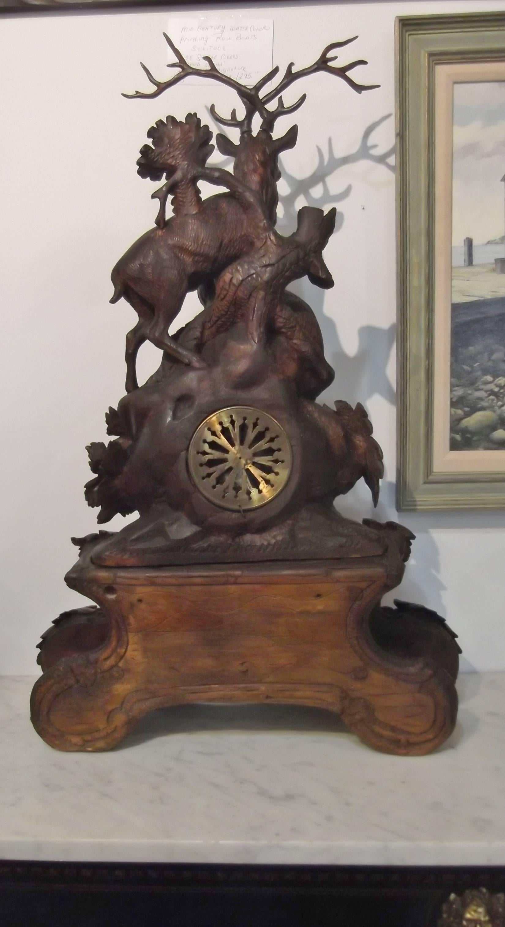 An impressive Swiss black forest clock with stag and ibex on top.
Exceptionally carved with mother fox, three baby foxes, one climbing in a cozy hollow (den). This impressive clock is in two parts and has been recently cleaned, serviced and runs