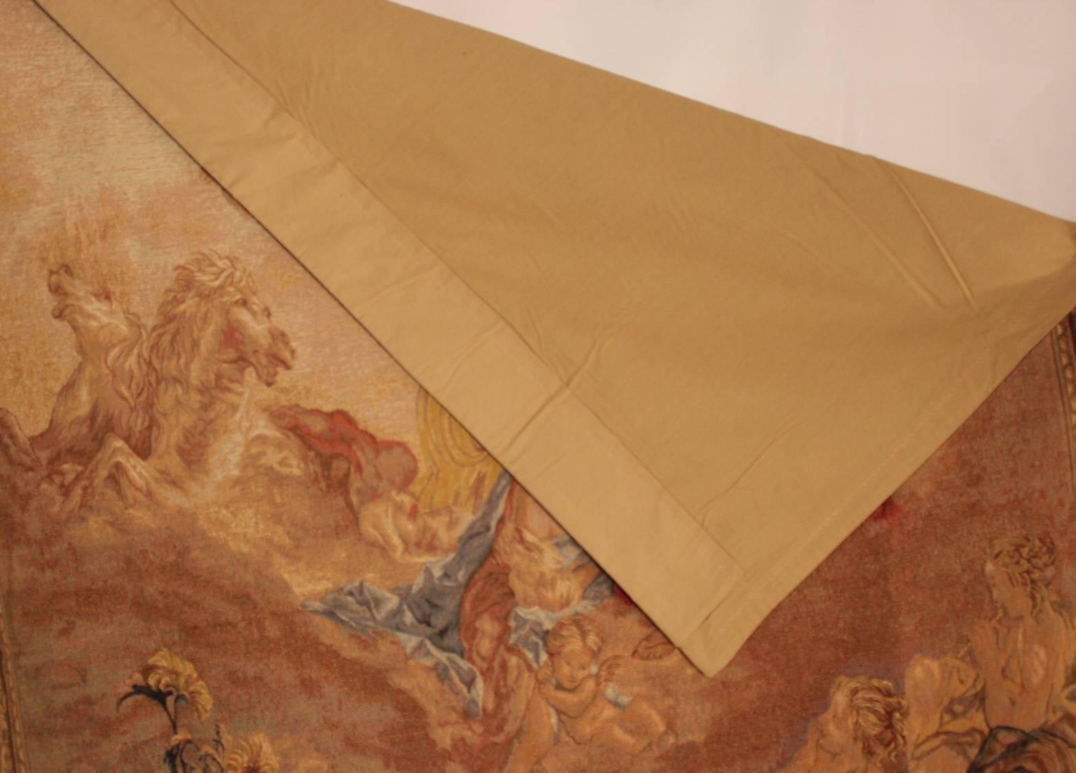 A 20th century cotton and wool machine woven tapestry made in Belgium. Reproduction of one from a set of nine mythological tapestries originally designed by Francois Boucher and woven at the Manufacture Royale de Beauvais. The arms at the top are