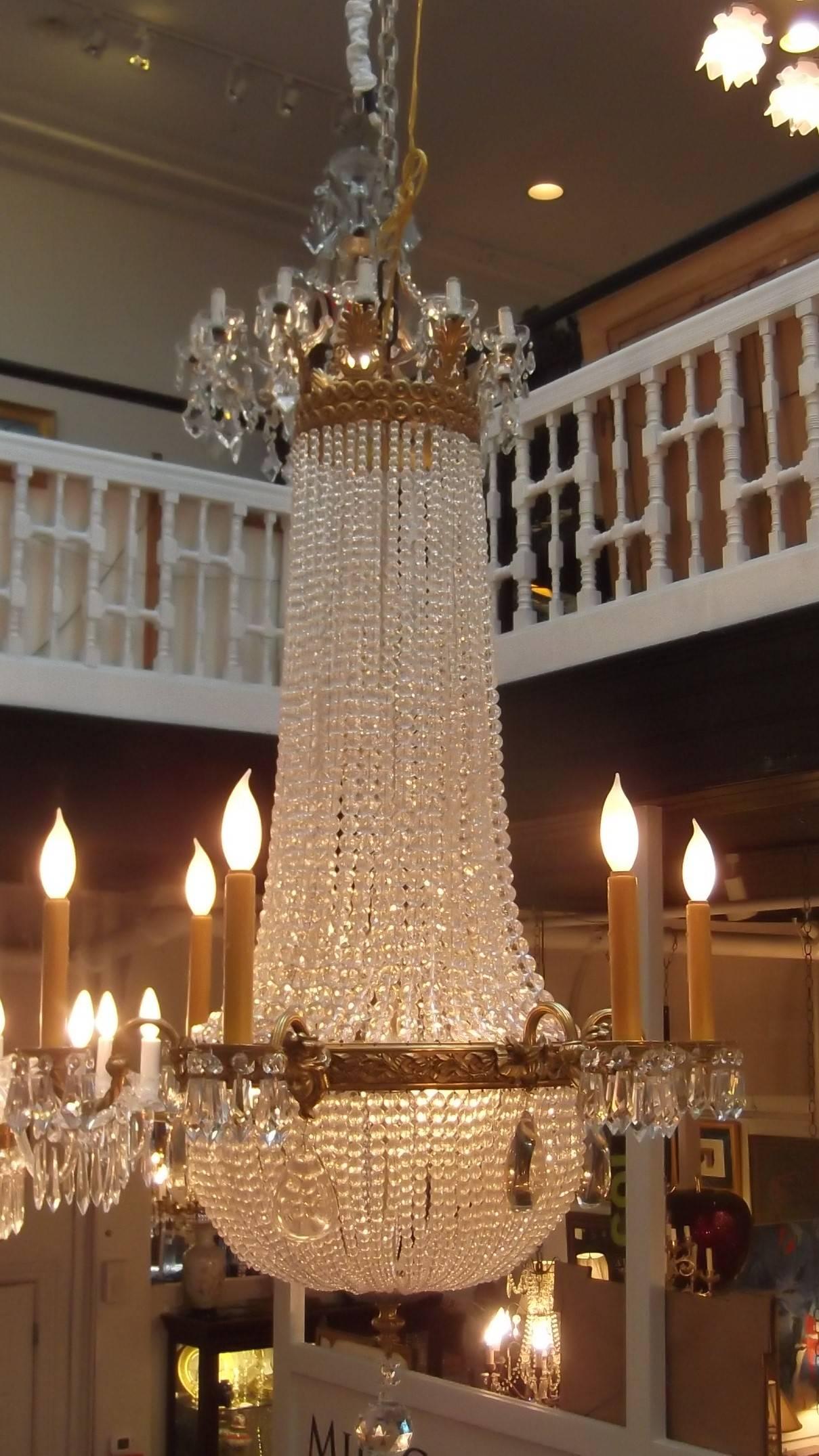 Exceptional gilt bronze and beaded crystal chandelier with six arms and six concealed interior lights. (Total of 12 lights) The casing on the gilt bronze is very good and the entire fixture has been cleaned, restrung and newly wired with new wax