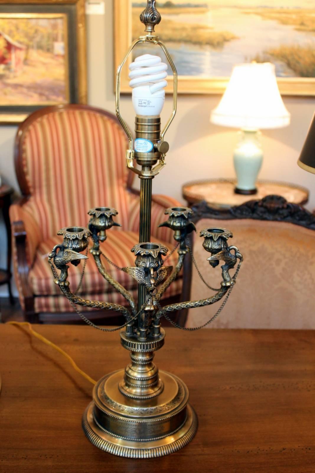 A pair of cast brass French style Bouillotte lamps with back parchment shades. Perfectly matched in the 19th century style with 20th century wiring and hardware. These are a quality pair of decorator lamps made in the late 20th century.