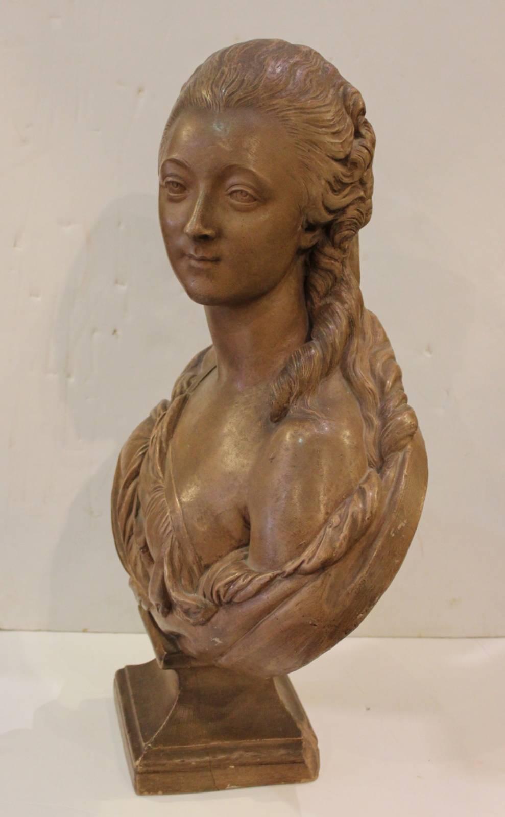 Large terracotta bust of a draped Madame Du Barry. Dressed in period clothing, resting on a square plinth base.
This French noble woman bust in the style Houdin a noted French sculptor.