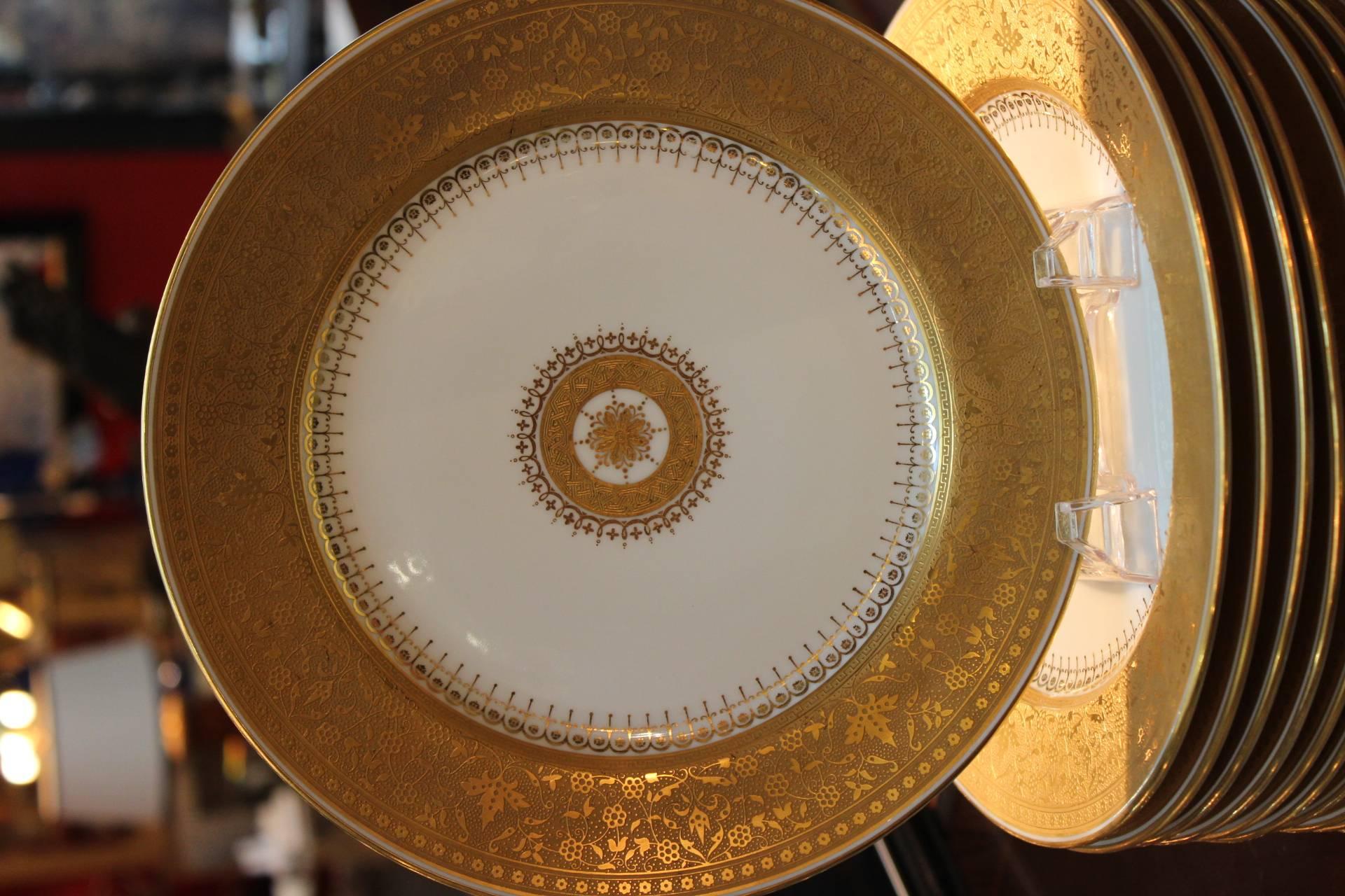 Graceful and elegant set of 12 service plates made in France. 

Signed TV Limoges France which stands for Tressemann & Vogt which was one of many factories doing business in Limoges, France at the turn of the last century.
The textured wide gold