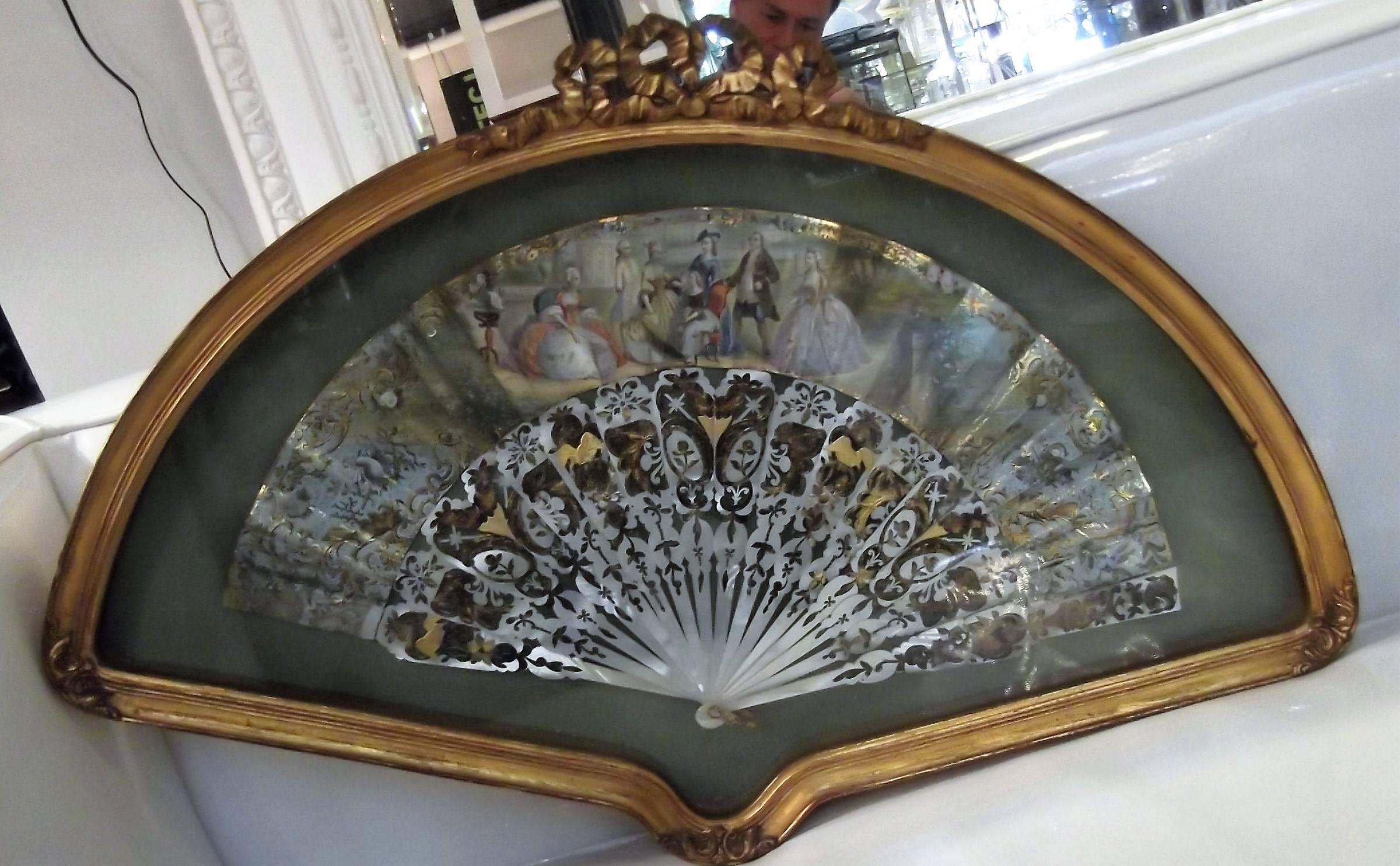 Antique mid-19th century hand-painted French fan with pierced mother of pearl   spokes. Beautifully presented in a custom gilt wood frame.  