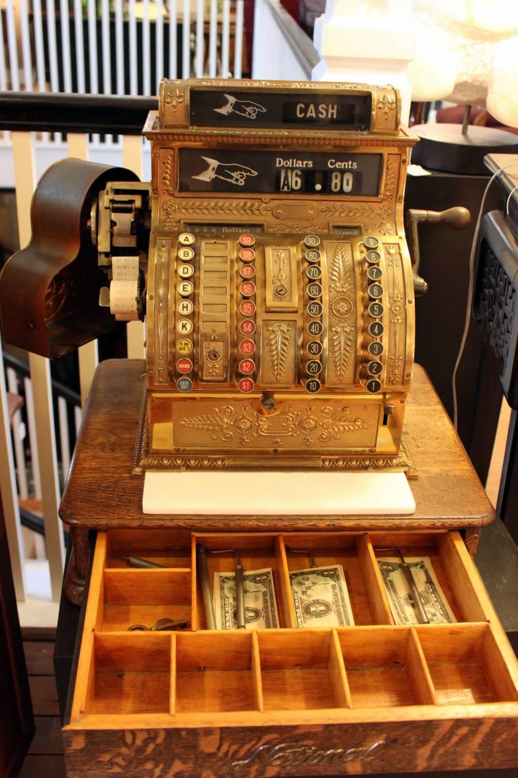 Absolutely beautiful, 1910-1915 antique national cash register # 1522669 441- model. Brass with white glass ledge and original solid oak base. Keys and crank work perfect to open drawer. Five rows of keys. Six clerk keys (A, B, D, E, H & K) with