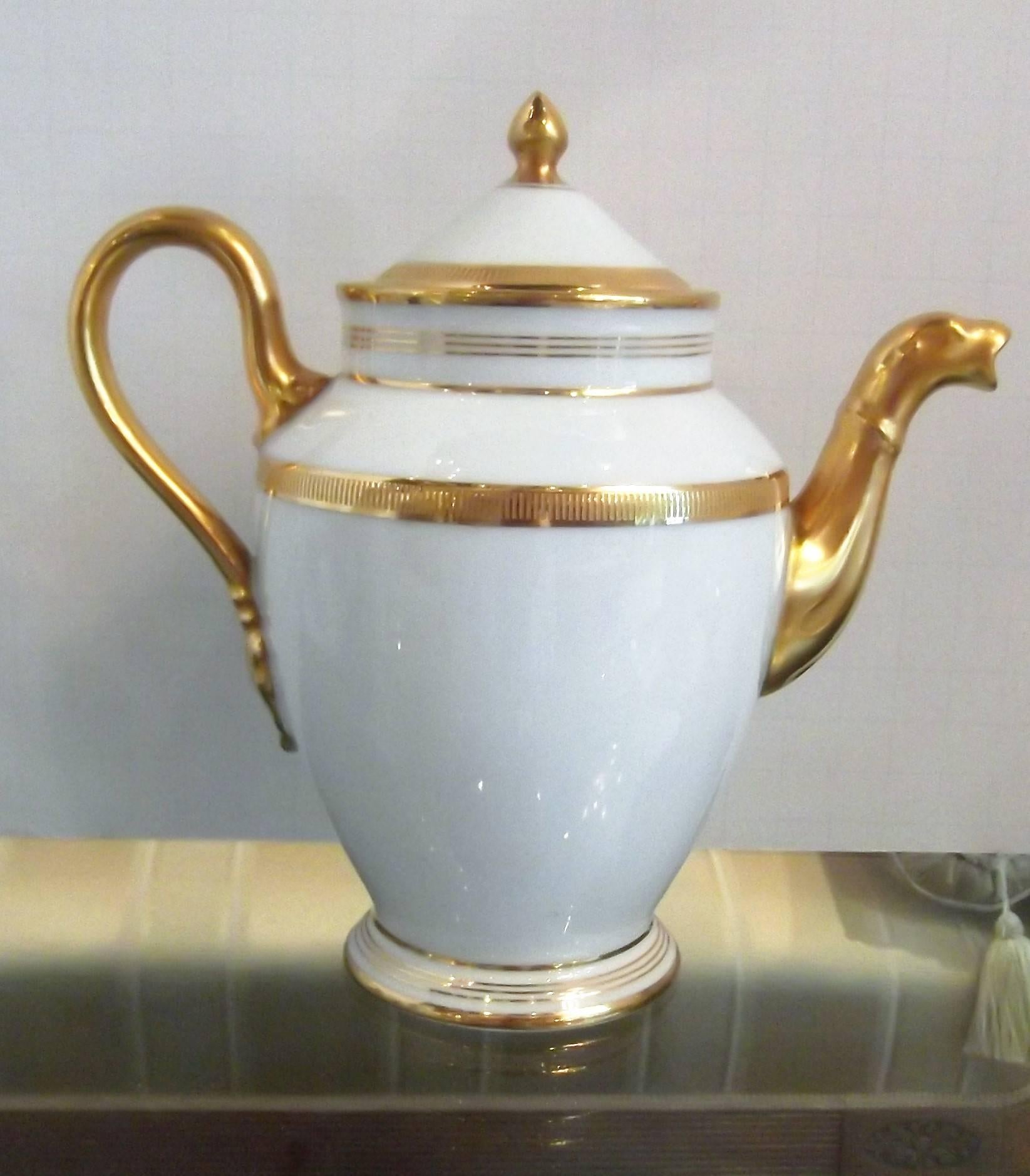 Elegant gold and white Espresso coffee set made by Italian maker Richard Ginori. R. Ginori is considered the Ferrari of Italian porcelain makers well designed and timeless styling. The set includes a small espresso pot, tall creamer, covered sugar