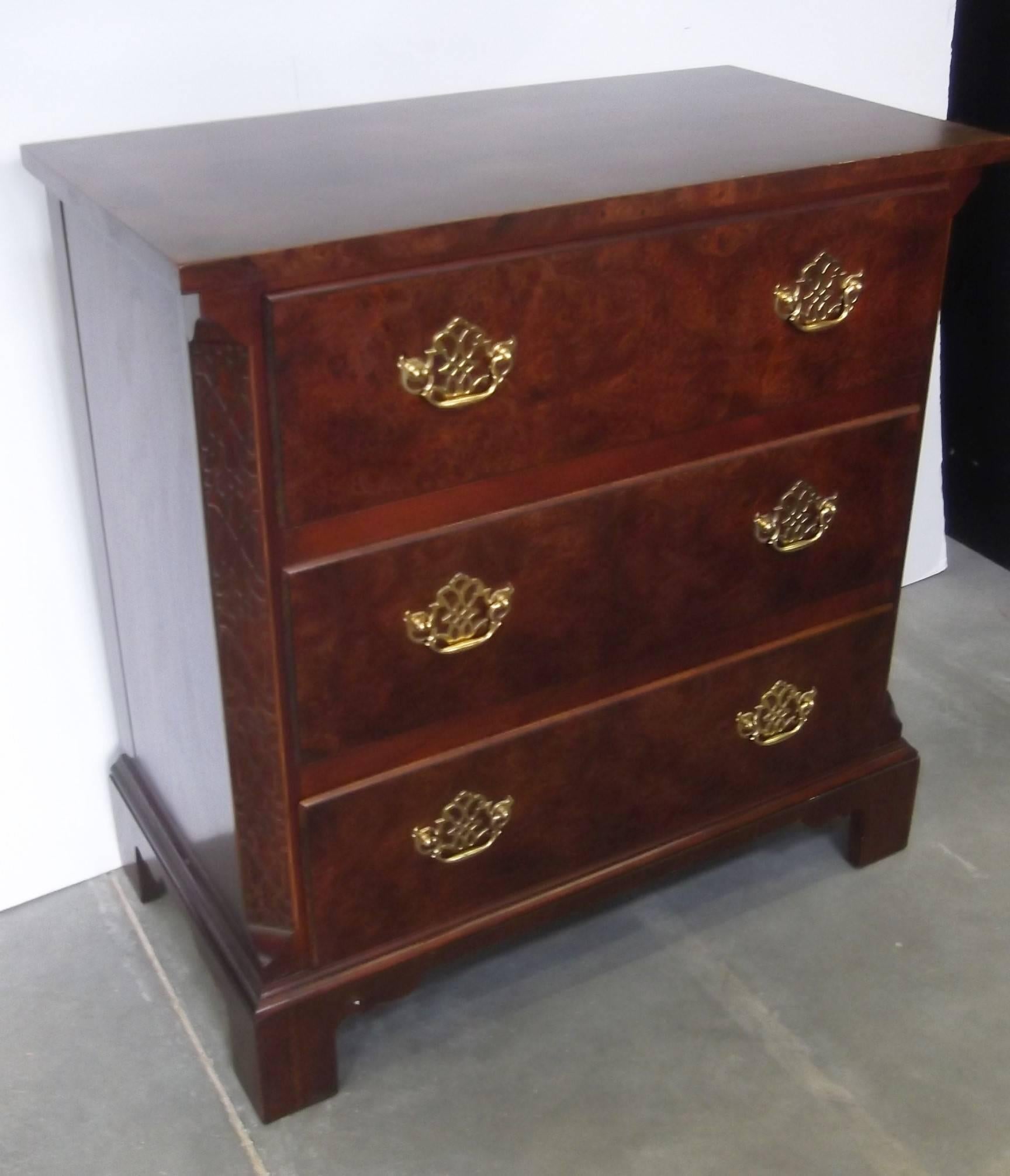 Mahogany Chippendale style three-drawer bachelors chest with pierced shield back drawer pulls. The mahogany case with burl drawer fronts resting on bracket feet. This is a 20th century version made by the premier American maker, Baker furniture.