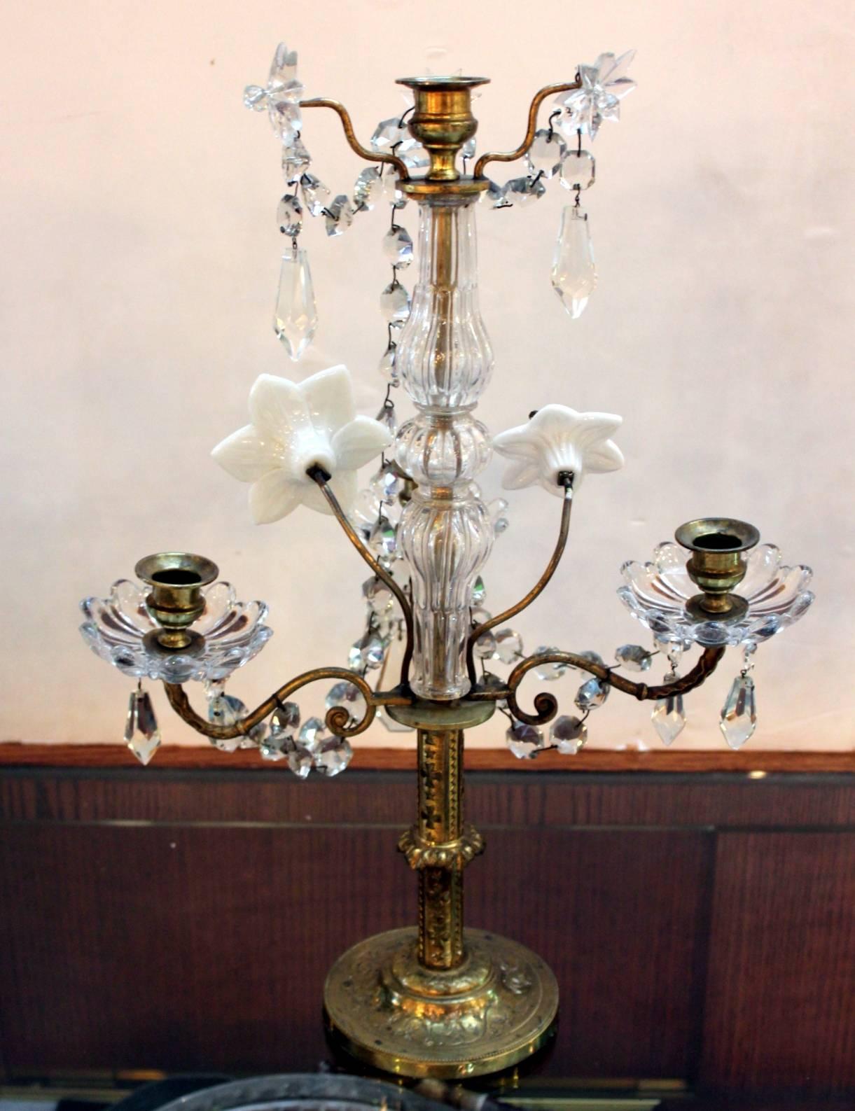 Beautiful pair of French crystal and opaline glass girandoles with four arms. This pair accommodates candles with one center and three additional arms in the front., the center portion has handmade white oplaine glass flowers with overall glass