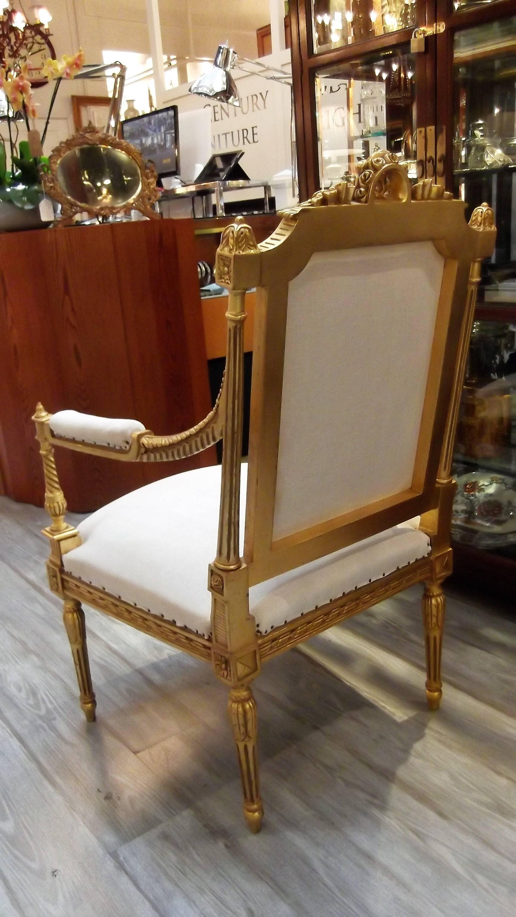 A pair of elegant hand-carved giltwood armchairs. Louis XVI style made in Egypt in the French taste. These chairs are covered in a plain muslin cotton, ready to have the final fabric upholstered on them.