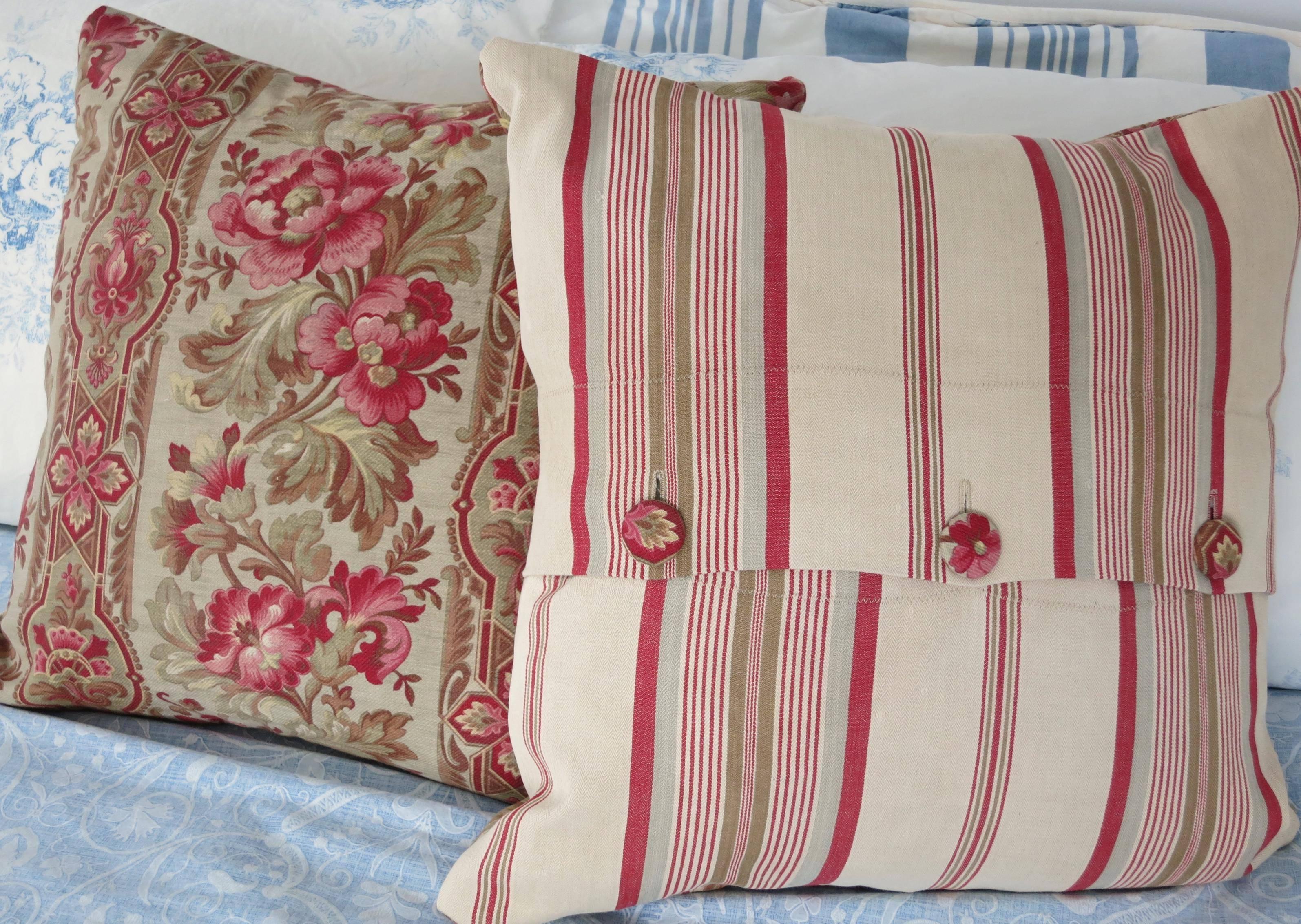 These gorgeous pillows features:

 The front: Lovely antique printed cotton cretonne dating from circa 1890. Truly outstanding and beautiful floral motif of warm earth tones and shades of pink and red.
 The back: A superb coordinating khaki, tan,