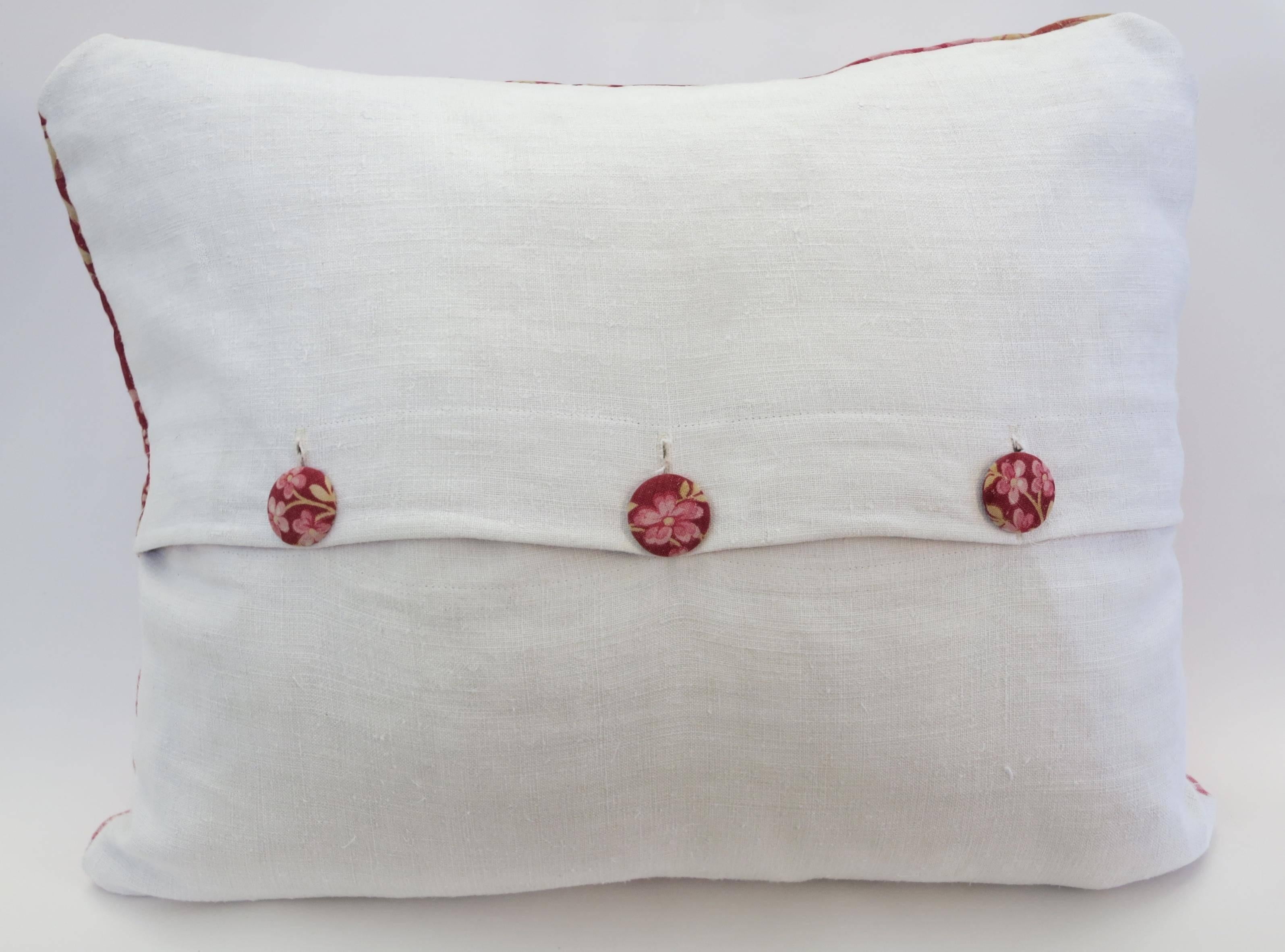 This pillow features so much beautiful history:
*The Front: The top is a 19th century floral textile that was once quilted, evident by the pinhole motif. A deep red background is highlighted with varying shades of pinks and golds. Some very light