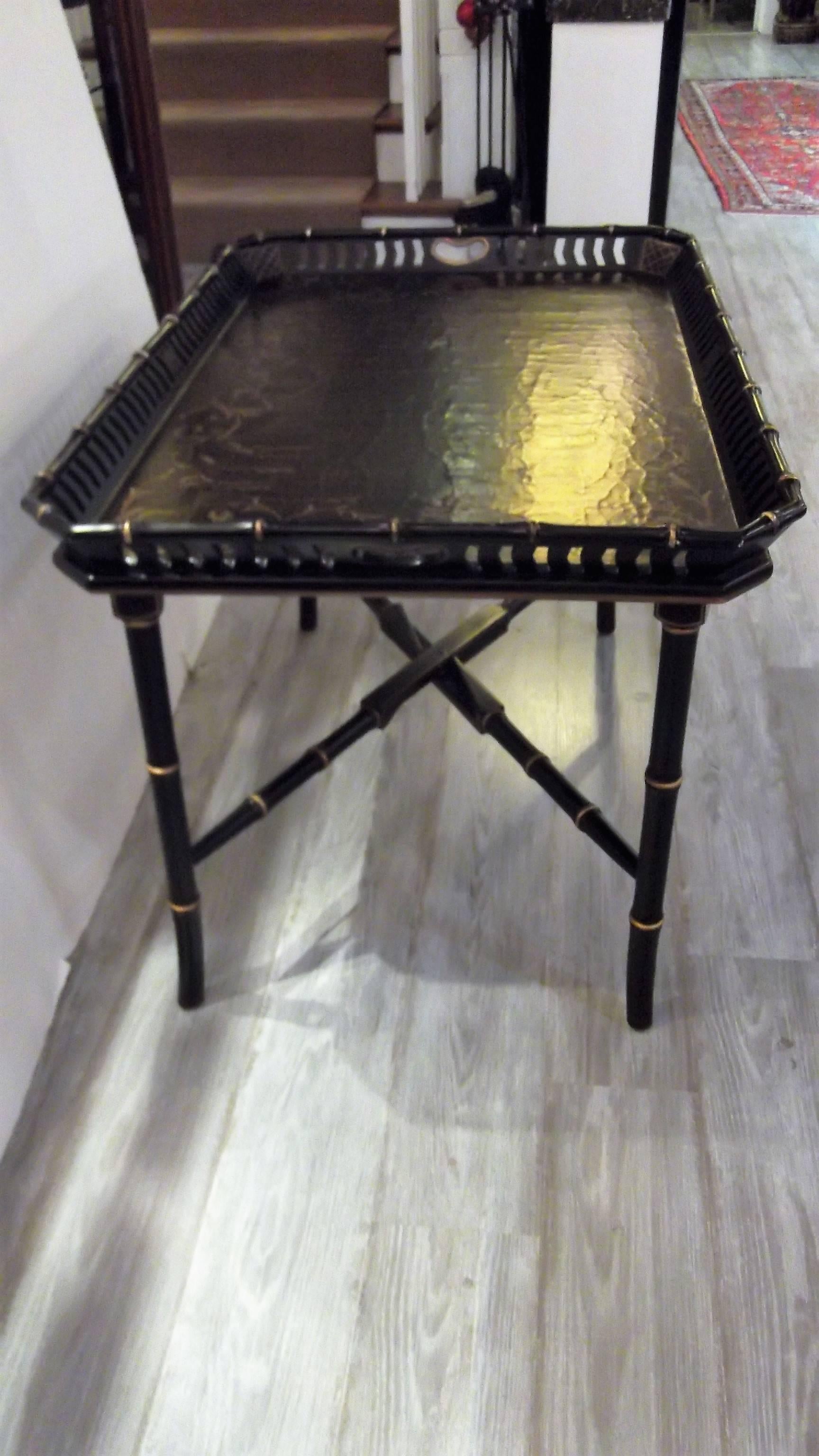 A decorator chinioserie tray top table with gilt highlights. The tray has a reticulated gallery with a bamboo motif edge. The top is finished in a crackled aged surface. The tray rests on a Regency style bamboo motif base.