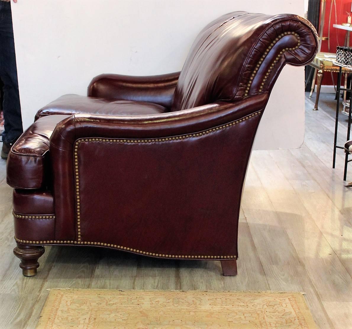 Handsome English style all leather roll back small sofa made by Hancock and Moore. The hand tailored leather is highlighted by antique brass nailhead trim. The frame is a kiln dried hard wood with eight-way hand tied hourglass springs. The feet are