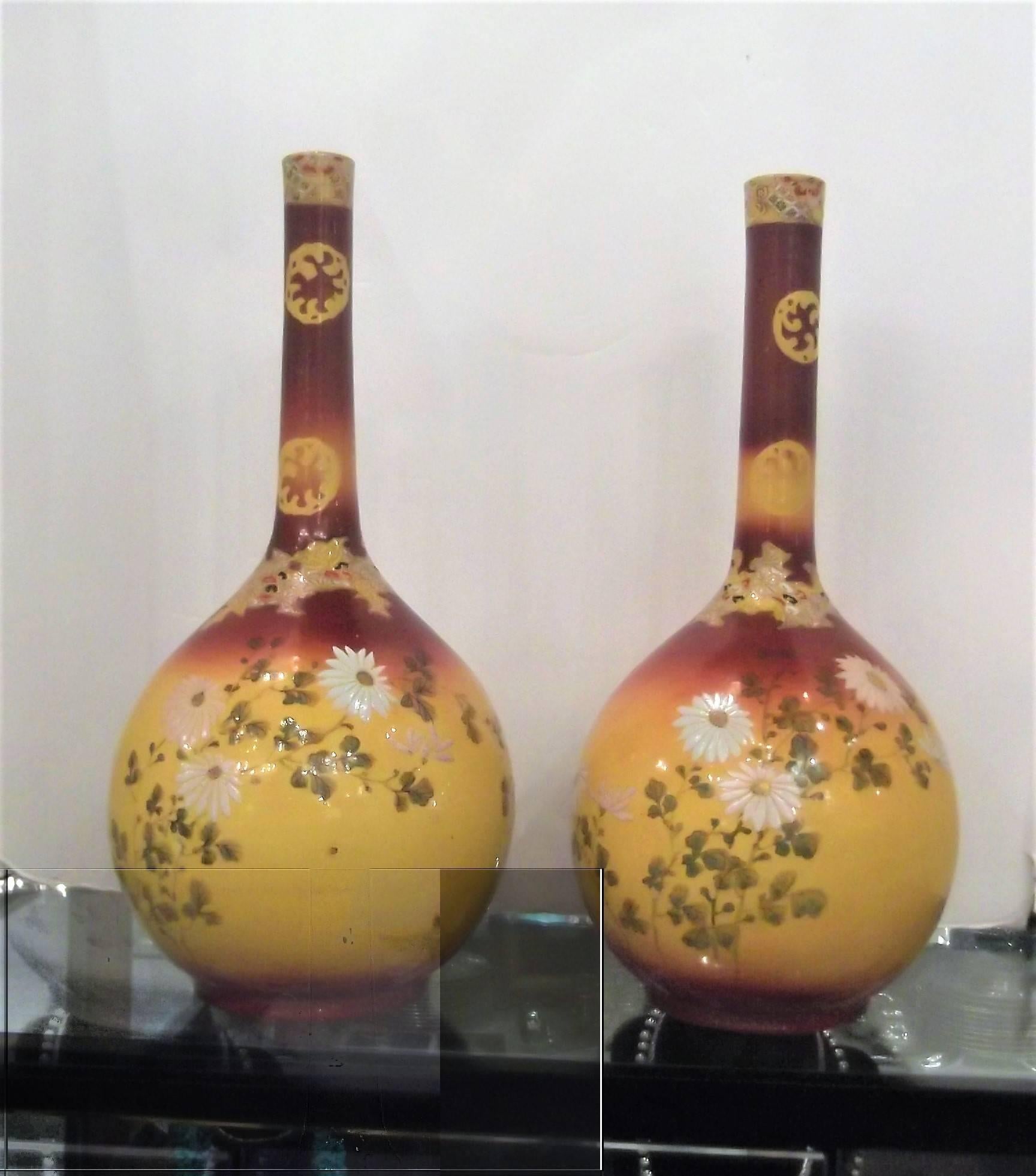 Beautiful handmade pair of long necked vases with hand-painted and decorated bulbous bodies. 
Awaji Pottery was made on the Japanese island of the same name between 1830 and 1939 
The Awaji potters were masters of their Craft who had an innate