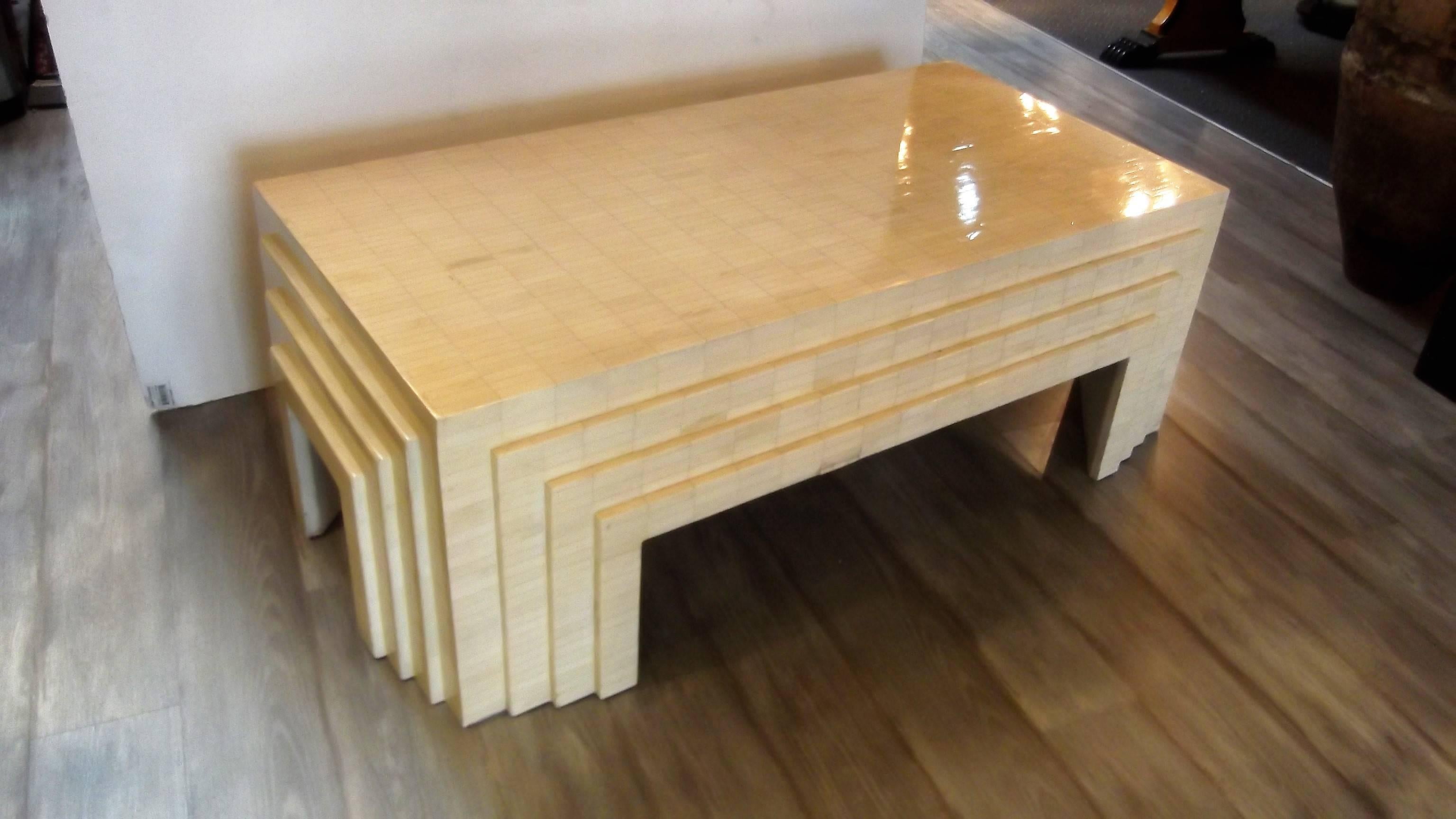 A Mid-Century modern design coffee table in the manner of Karl Springer. The entire surface is covered in mini subway bone tiles. The front, back and sides have a cityscape step design giving this table high style and dimension.