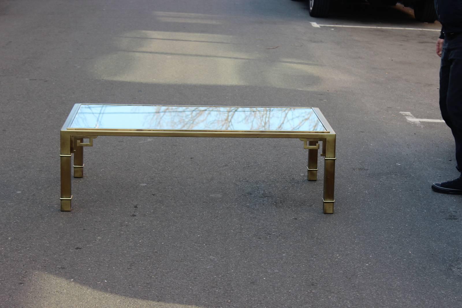 1970s Greek-key brass and glass cocktail table by Mastercraft. Original beveled glass top. Light wear to original glass.
  