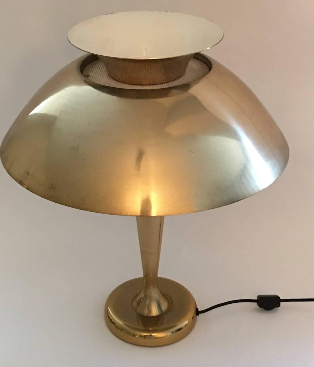 Art moderne anodized spun aluminum table lamp, gold tone in the style of Soundrite Corp. 

Description: Pedestal rests on a weighted circular base and widen from base toward top, two tier dome shade including inverted dome top. 
 Attributed to