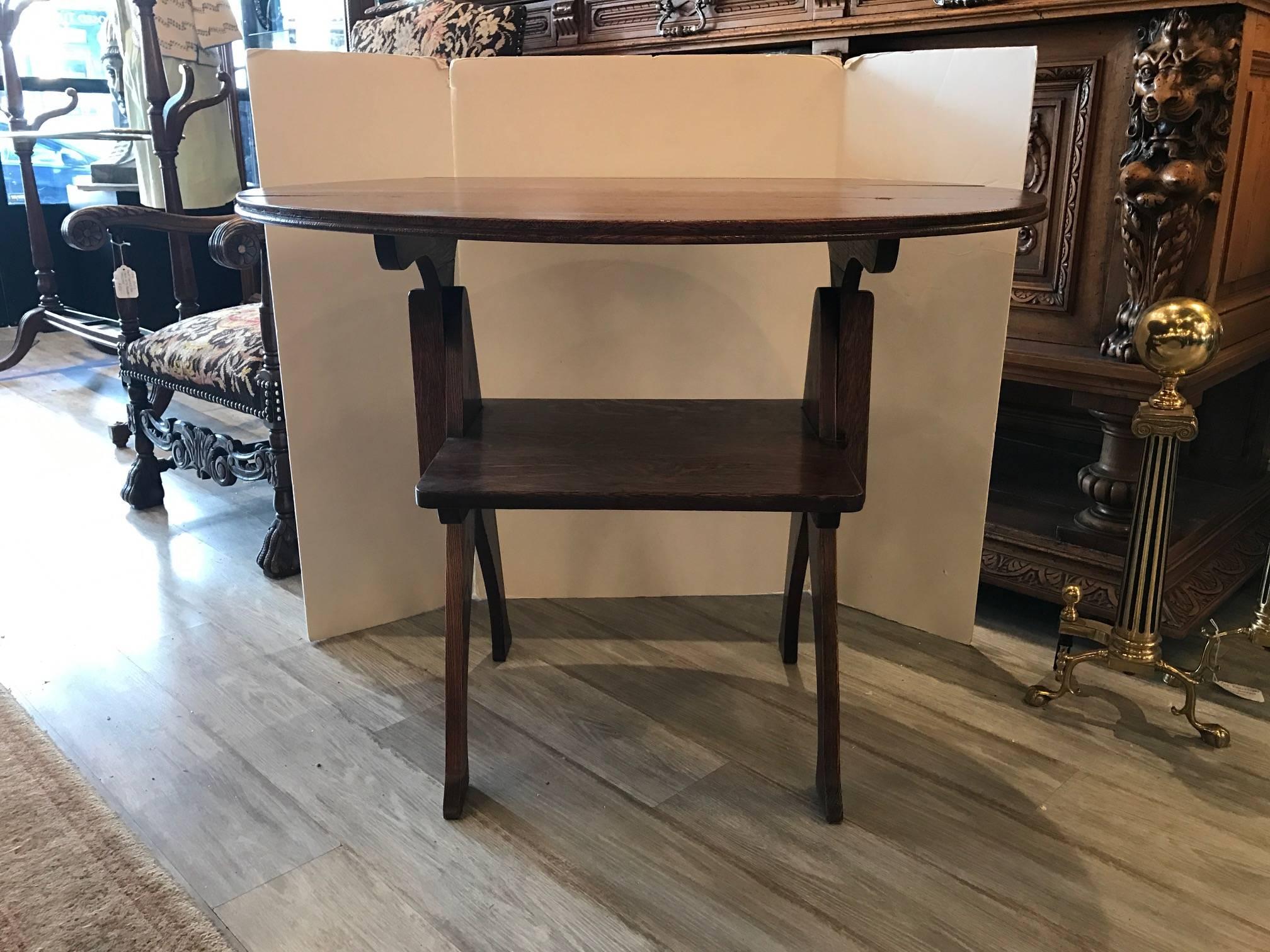 Unique arts and crafts oak table that converts into a chair. In quarter sawn oak to enhance the grain, with an oval top that folds back and locks in place with a wooden pin when used as a chair. The form of this piece is 18th century and this piece