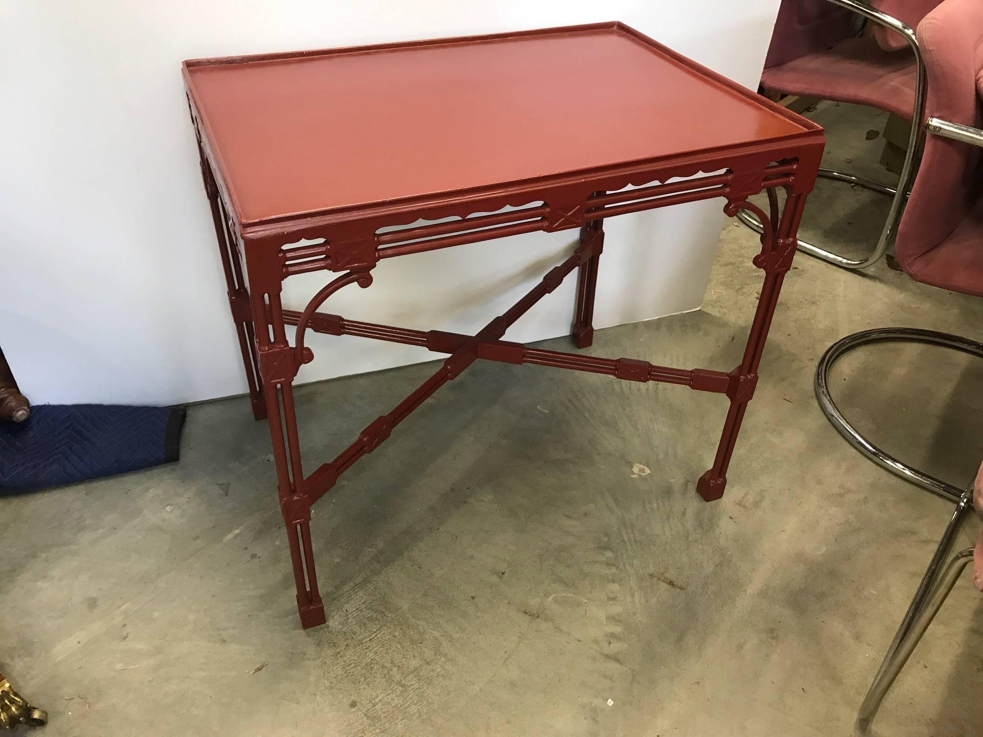 A traditional Chinese Chippendale English style tea table. This Classic styled table is lacquered in a cinnabar red and can be used in a traditional or more modern setting. The square top with slight gallery edge is supported by four legs made of