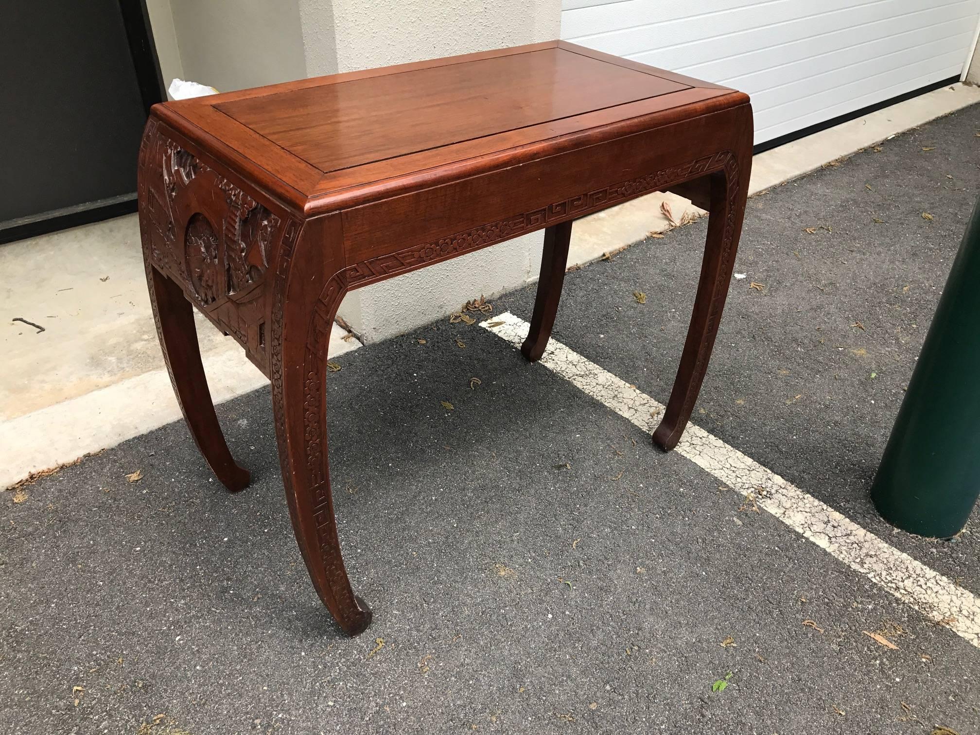 Elegant hand-carved Chinese console altar table. The Classic Asian form with bowed legs accented by hand-carved borders. The side panels are carved in Chinese village scenery. This table is a great size for smaller space measuring 36 inches at its