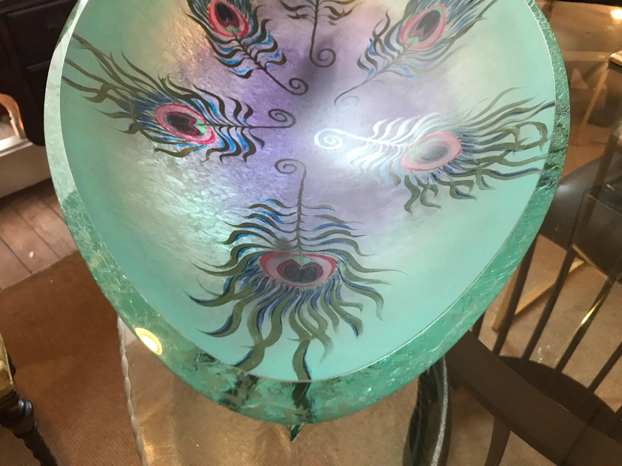 Large art glass peacock sculptural center bowl hand-painted and fired. Oval shape is higher on one side than the other, 8 inches on one side, 10 inches on the other. The bowl is attached to the base by amethyst sculpted glass arms with a diamond