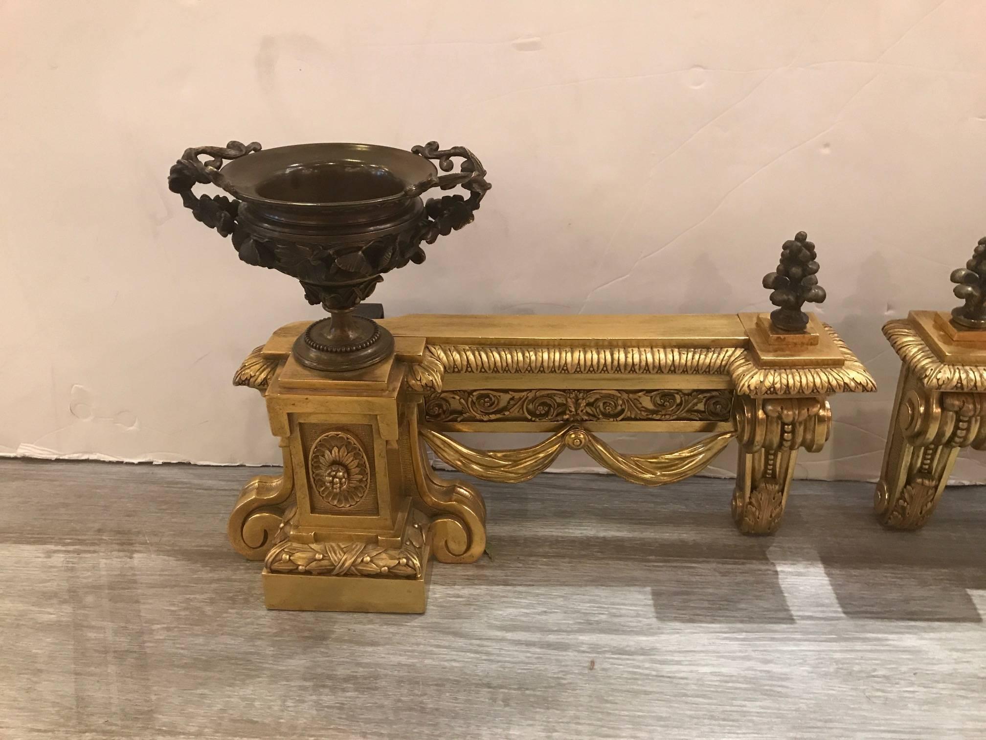 A beautify cast pair of bronze Louis XV style andiron chenets. The patinated bronze urn form with crisply cast and highly detailed bronze doré bases, late 19th century, France.
