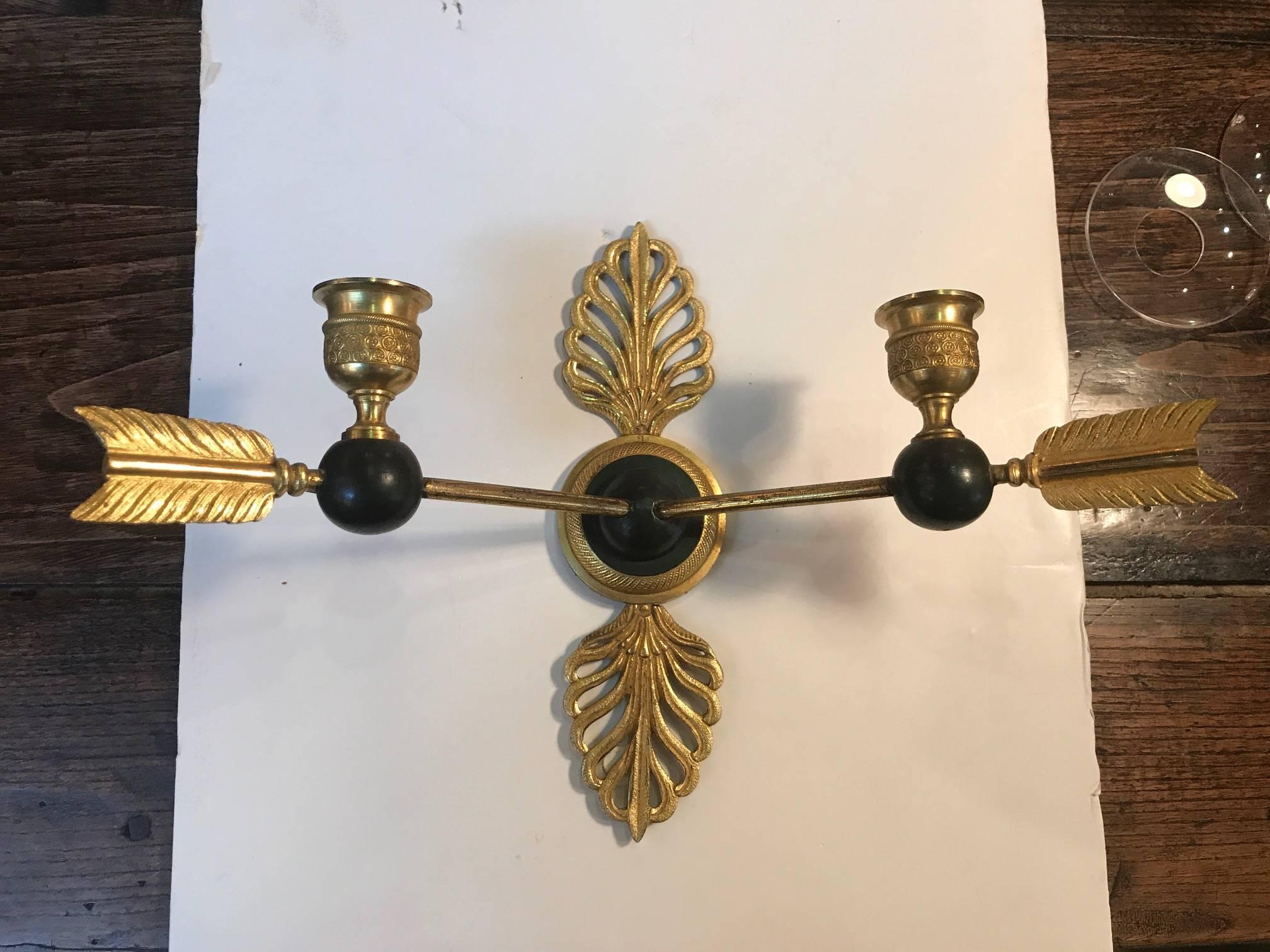A pair of Empire neoclassical bronze candle sconces. Made in France in the 19th century, these sconces have not been electrified but an electrician can do that if you choose.
