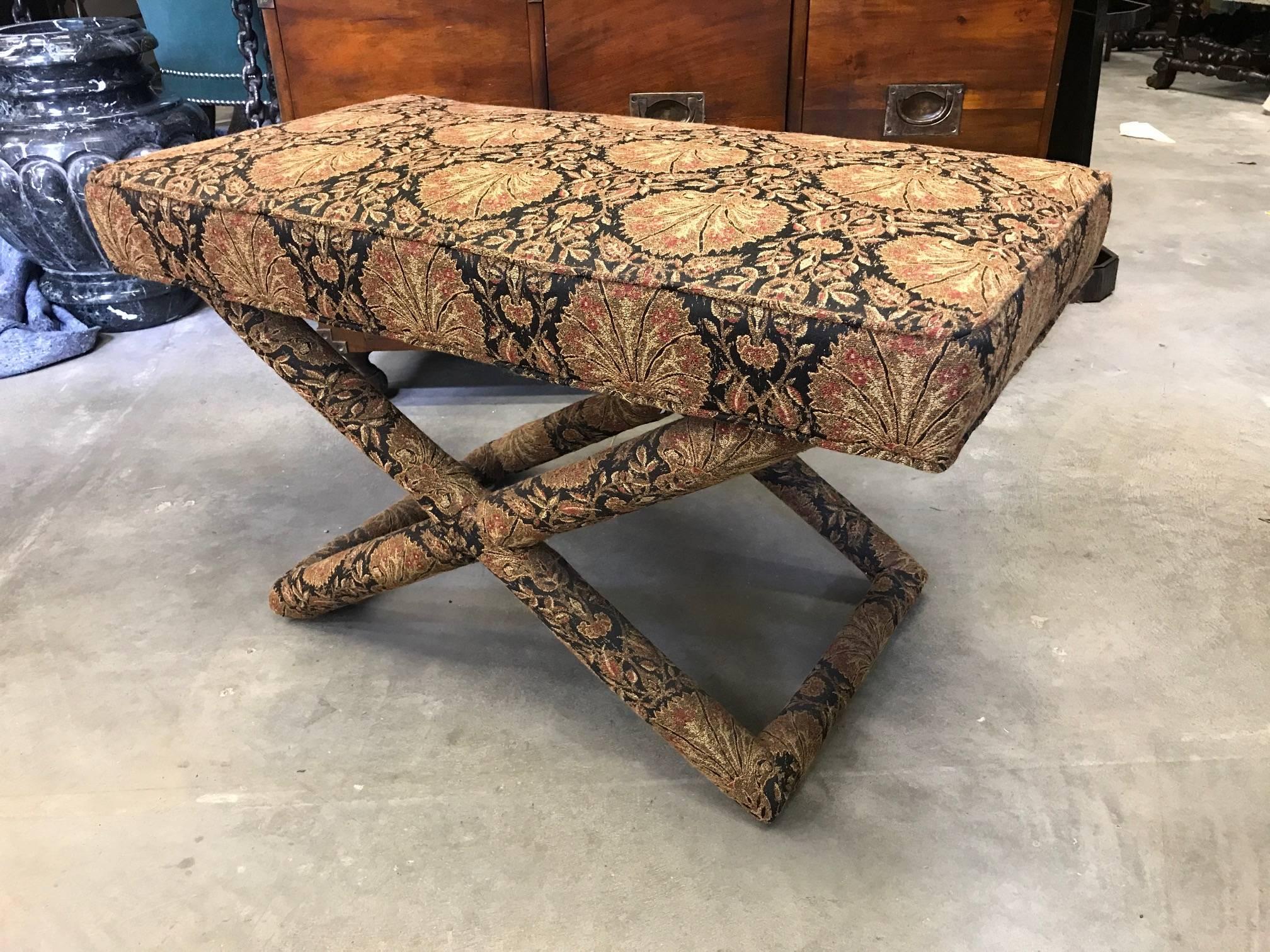 Milo Baughman / Billy Baldwin style, designed with Classic criss-cross legs, stretchers and slides on the bottoms, the bench is completely upholstered in a tapestry fabric.