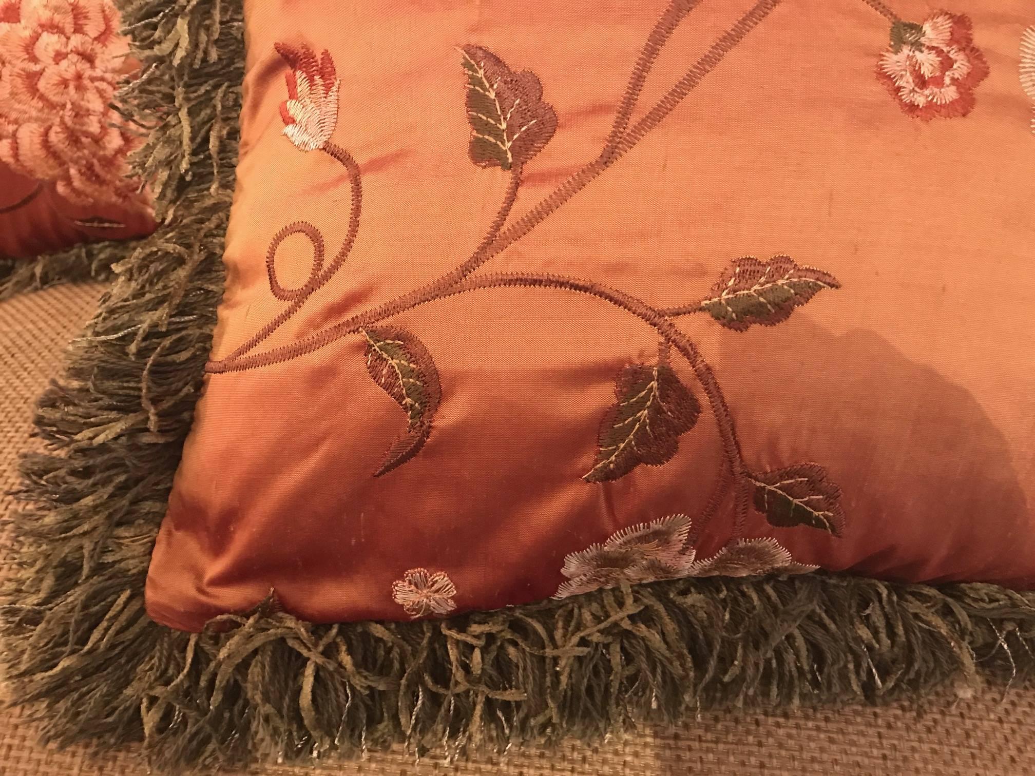 A pair of Coral color silk embroidered pillows with down and feather inserts. Elegant silk background with peony floral detail. Smaller size and perfect for a pair of neutral color chairs.