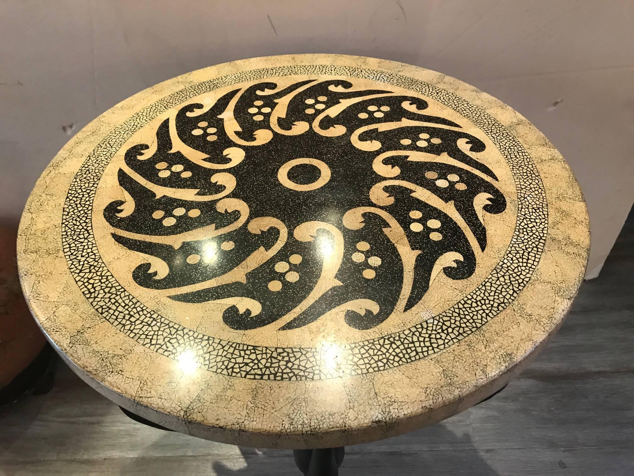 Unique round table with cast bronze base. The swan legs ending in ball and claw with triangular stretcher. The top with an ostrich egg mosaic design.