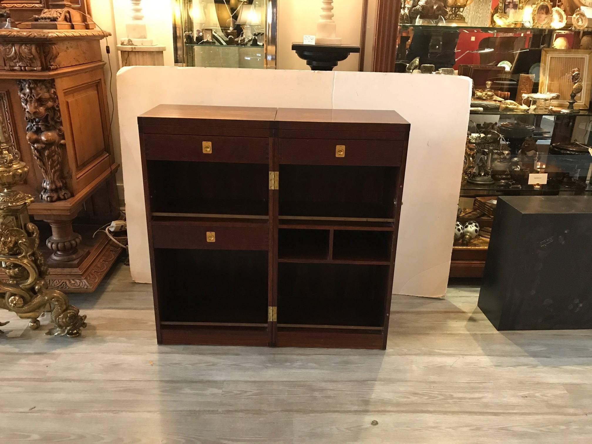 High style Danish rosewood bar cabinet by Dyrlund. The exceptional bar when closed is trim and tailored and opens up to reveal a functional bar with upper top that flips open. The interior is fitted with drawers and shelves. It is marked on the