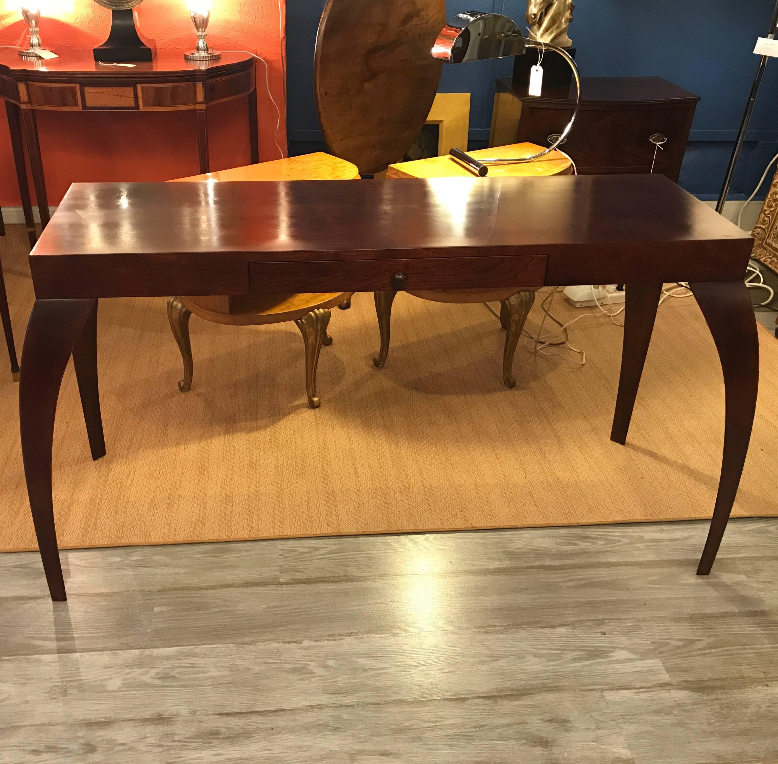 Sensual walnut console table by Dialogica of NYC. The top measures 15 deep by 48 wide the overall size is 20 deep by 53 wide. 
The founders and designers are Monique and Sergio Savarese. Before founding the space in 1989, Monique studied