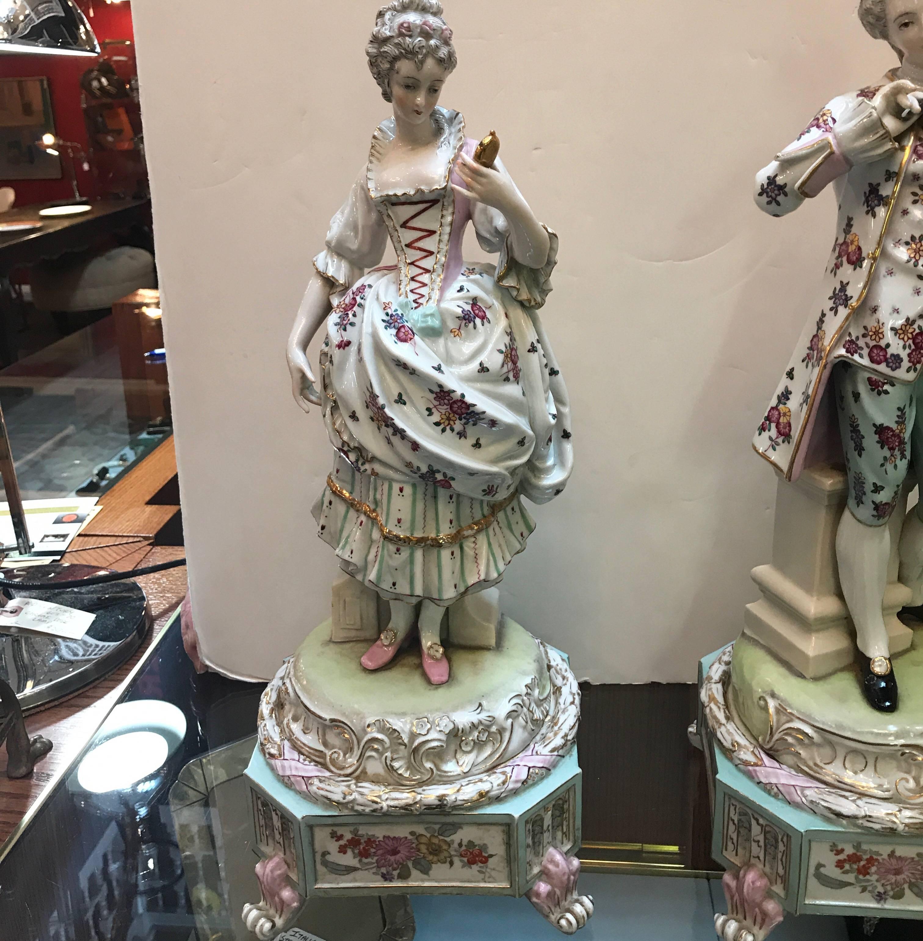 Exceptional pair of large Dresden hand-painted porcelain figures of an aristocratic couple. Both figures entirely hand-painted in great detail. These pieces are of Meissen quality but unmarked.