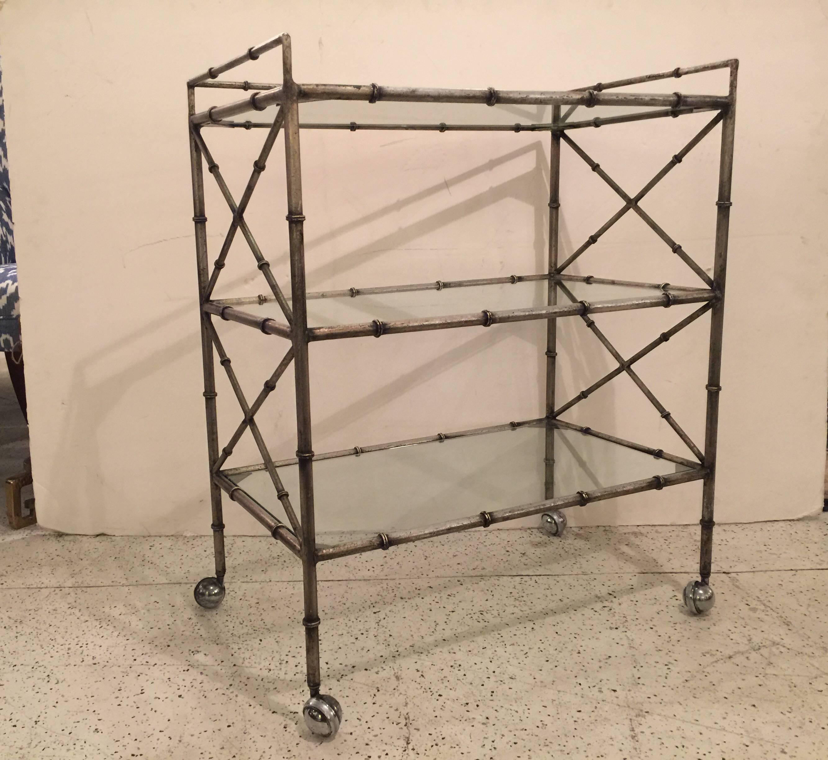 Nice solid iron and glass three-tier bar cart with silvered patina.