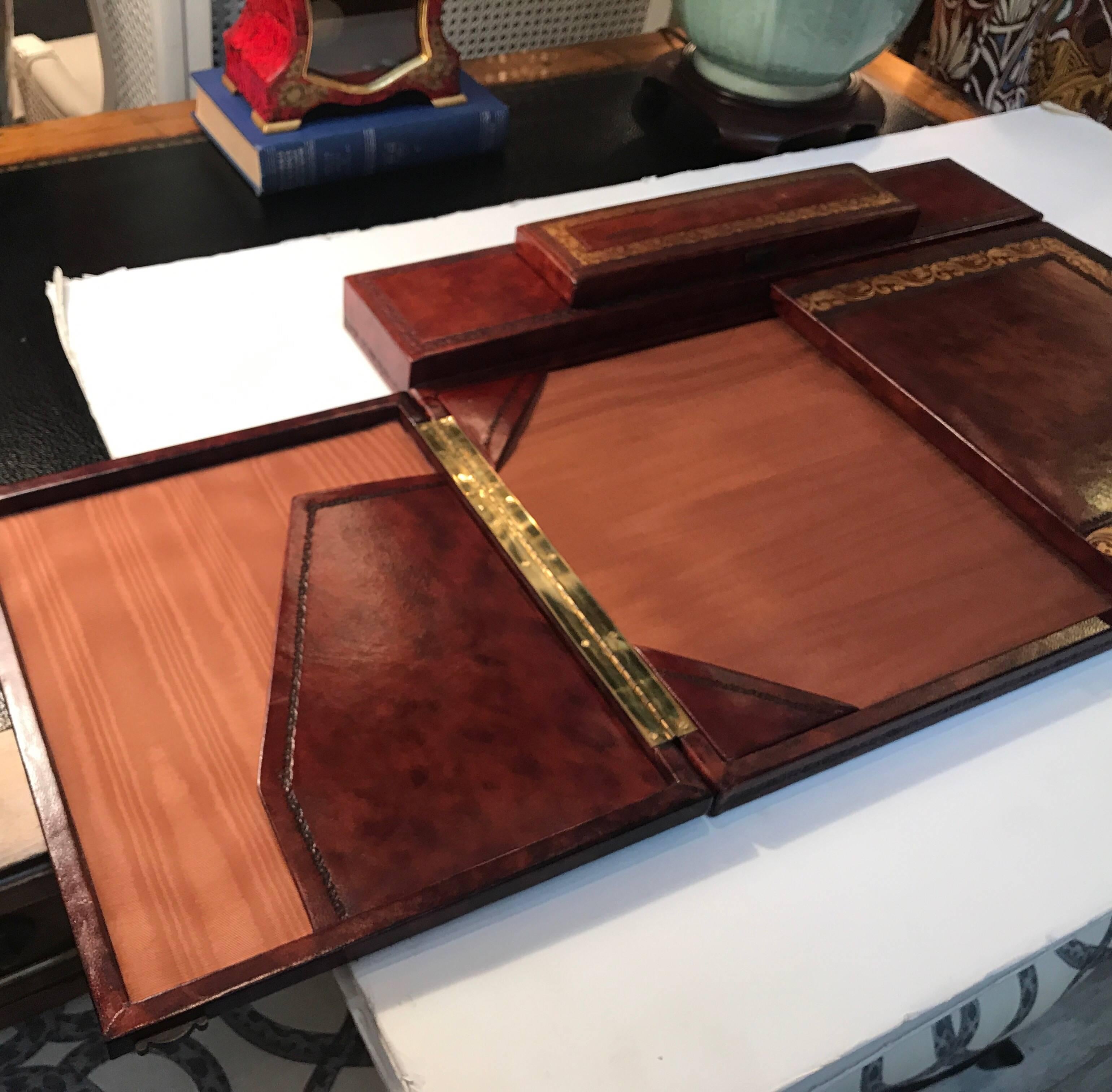 Sophisticated rich Italian leather desk organizer. The tooled leather surface, opens to reveal the blotter and pockets for writing paper. The top also has a hinged compartment for pens. Made by Horchow.