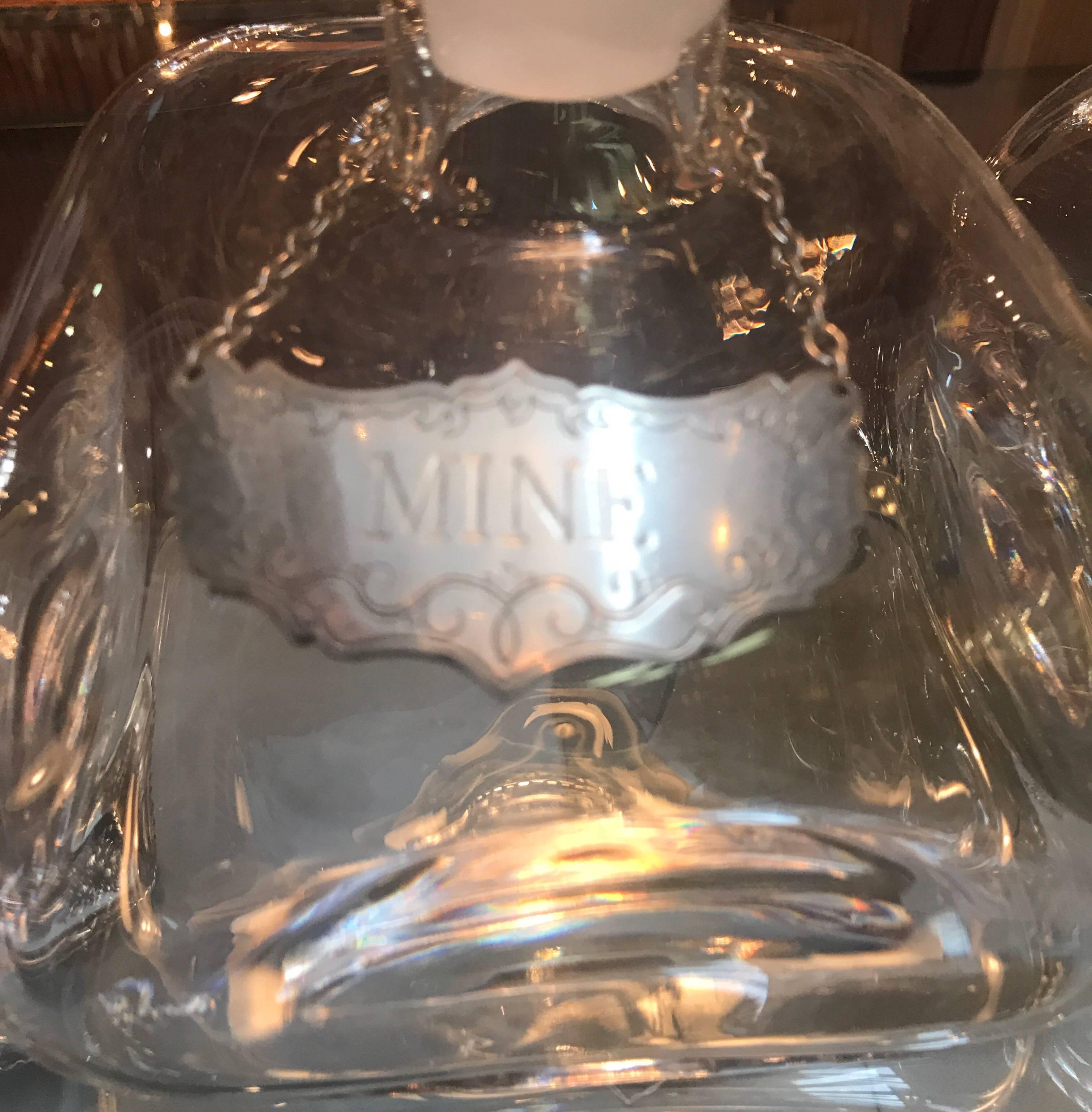 Unusual shaped blown decanters with engraved pewter labels, one saying yours, the other saying mine.