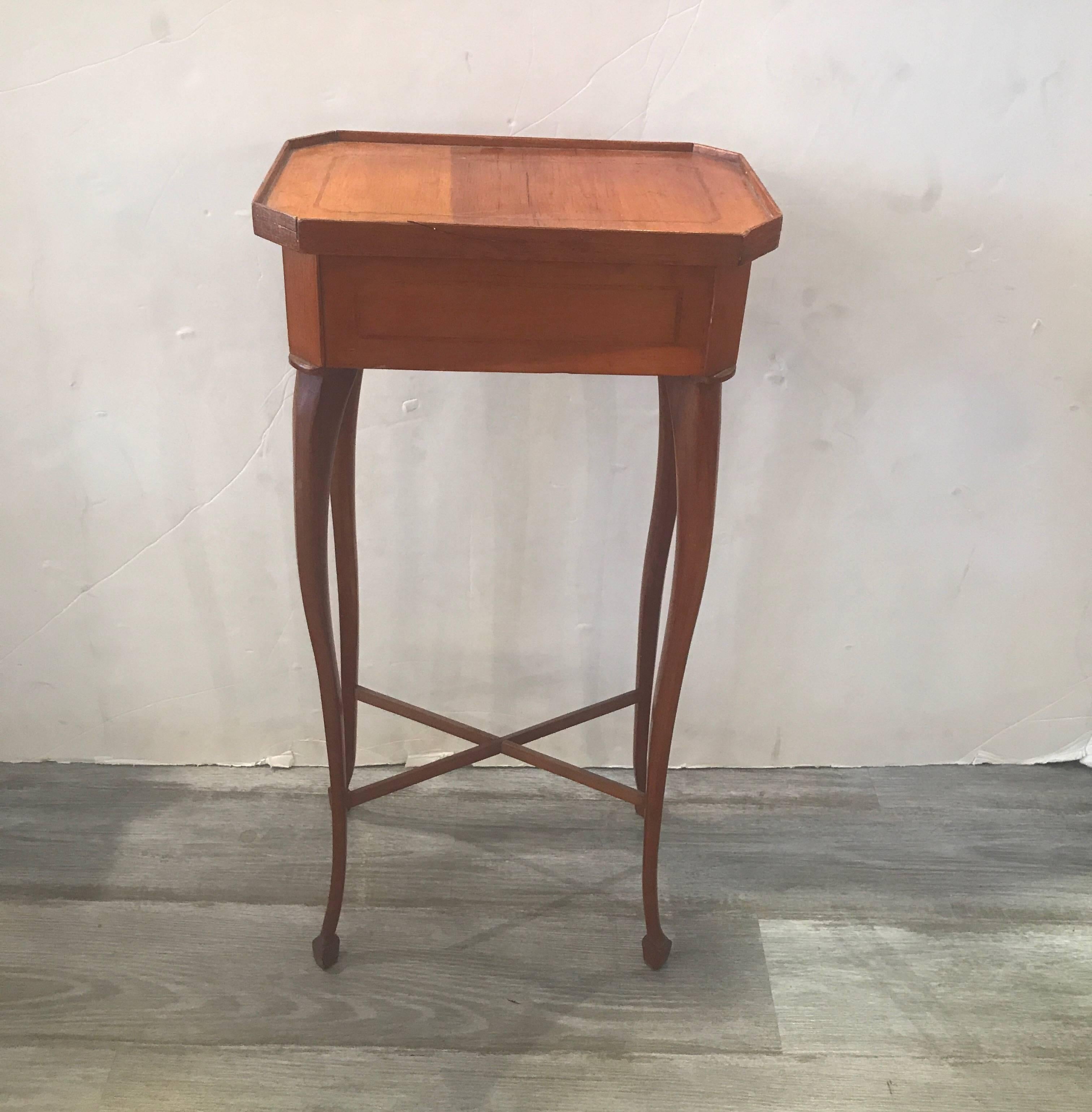 19th century Biedermier drinks side table with pencil inlay and stretcher base. A perfect small table for a narrow space between a pair of chairs.