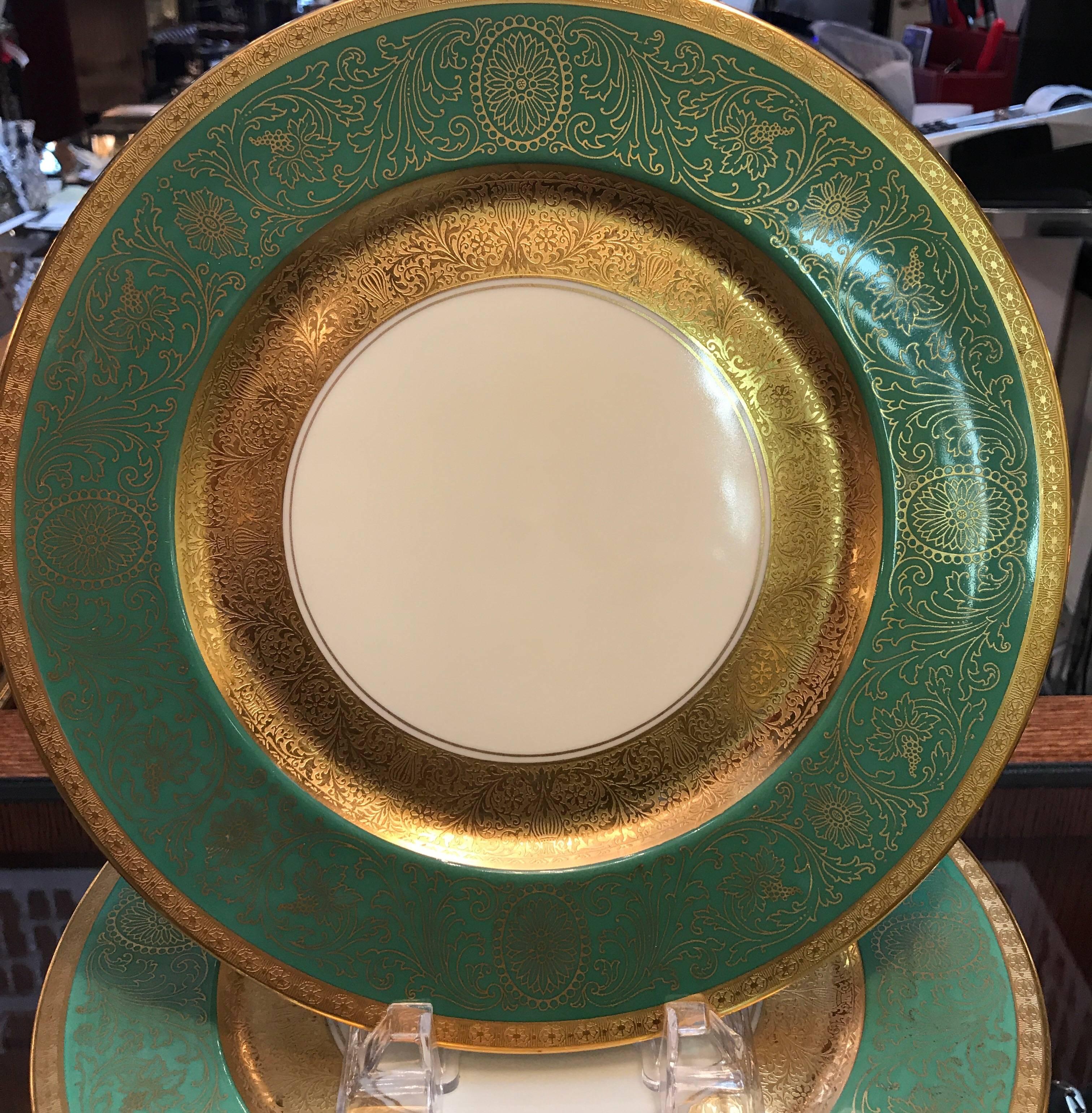 A set of ten gold encrusted and lavish service plates made by Heinrich of Germany and decorated by the Pickard Company the apple green borders with a broad central band with a lacy gilt overlay. The Pickard China story dates back to 1893 when Wilder