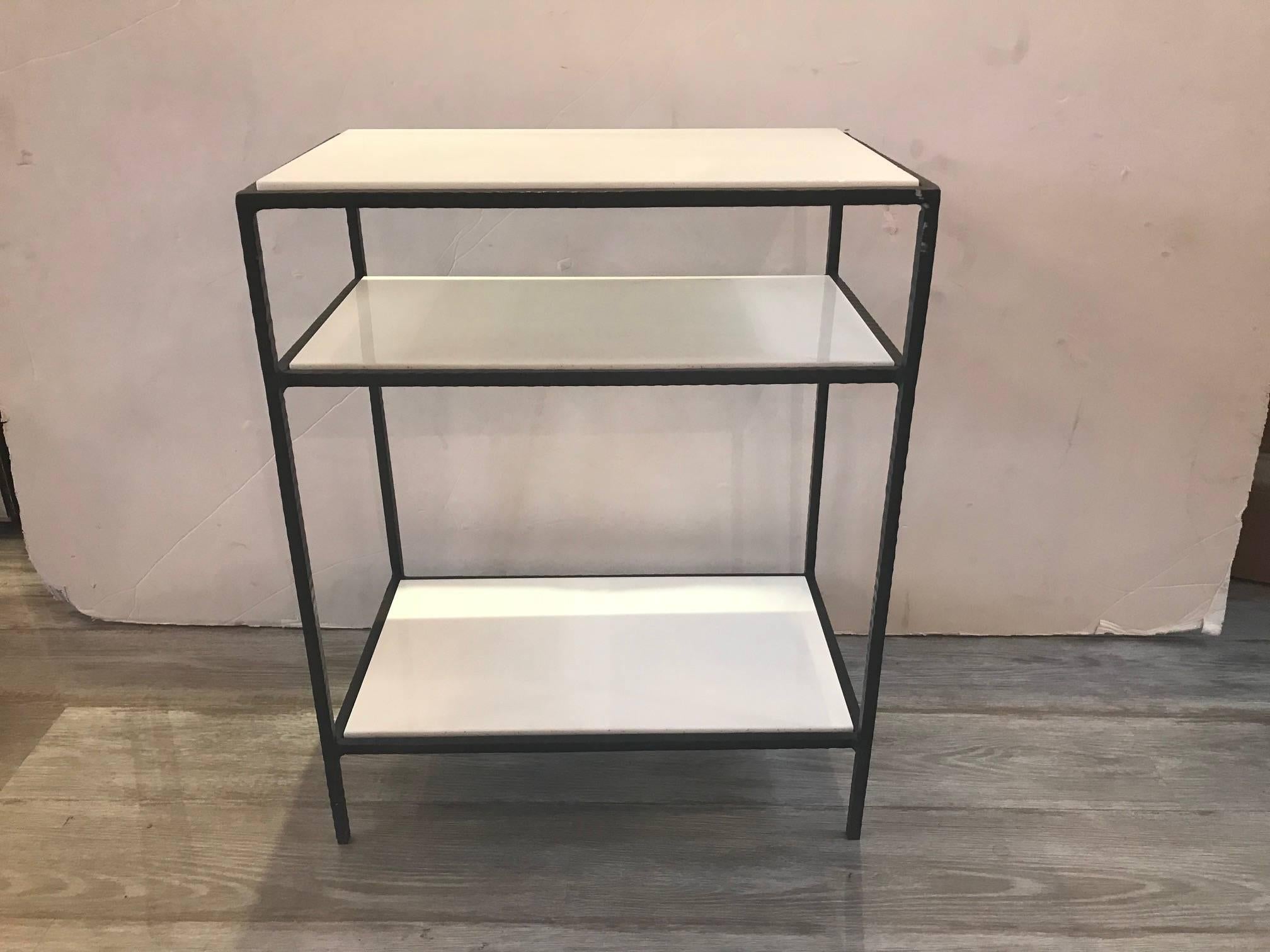 Very chic three-tiered side table with milk glass shelves. The glass is almost the color and consistency of Carrara marble. The hand-forged wrought iron frame is hand textured. Very solid and elegant piece.