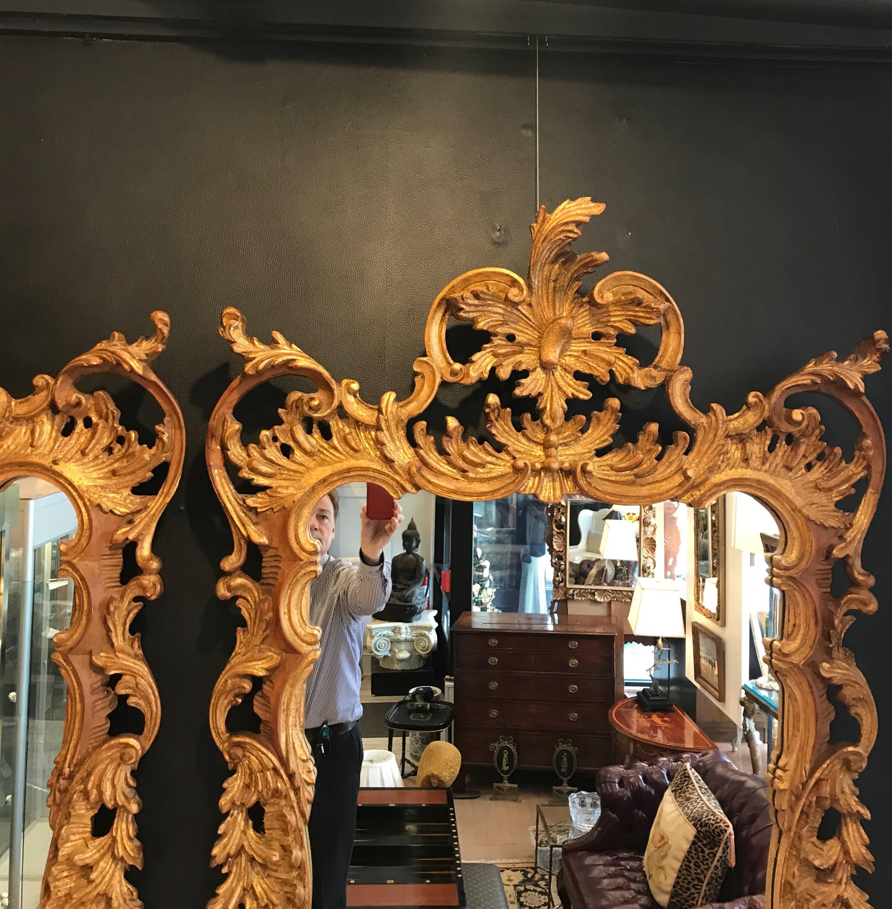 An extravagant pair of Italian Rococo Mirrors. The elaborate giltwood frames with plume pediment top surrounded by shapely scrolled decoration all around. Made in Italy for Labarge.