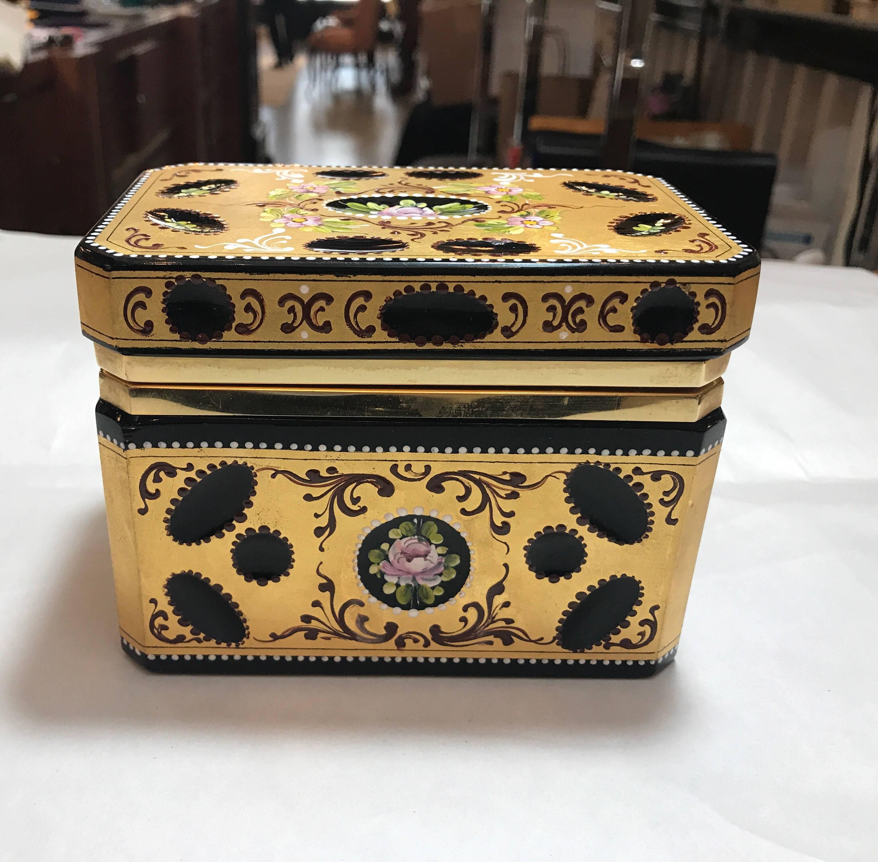 Opulent gilt and enameled onyx glass hinged table box. Elegant floral cartouches with heavy gilt surround and enameled bead work.