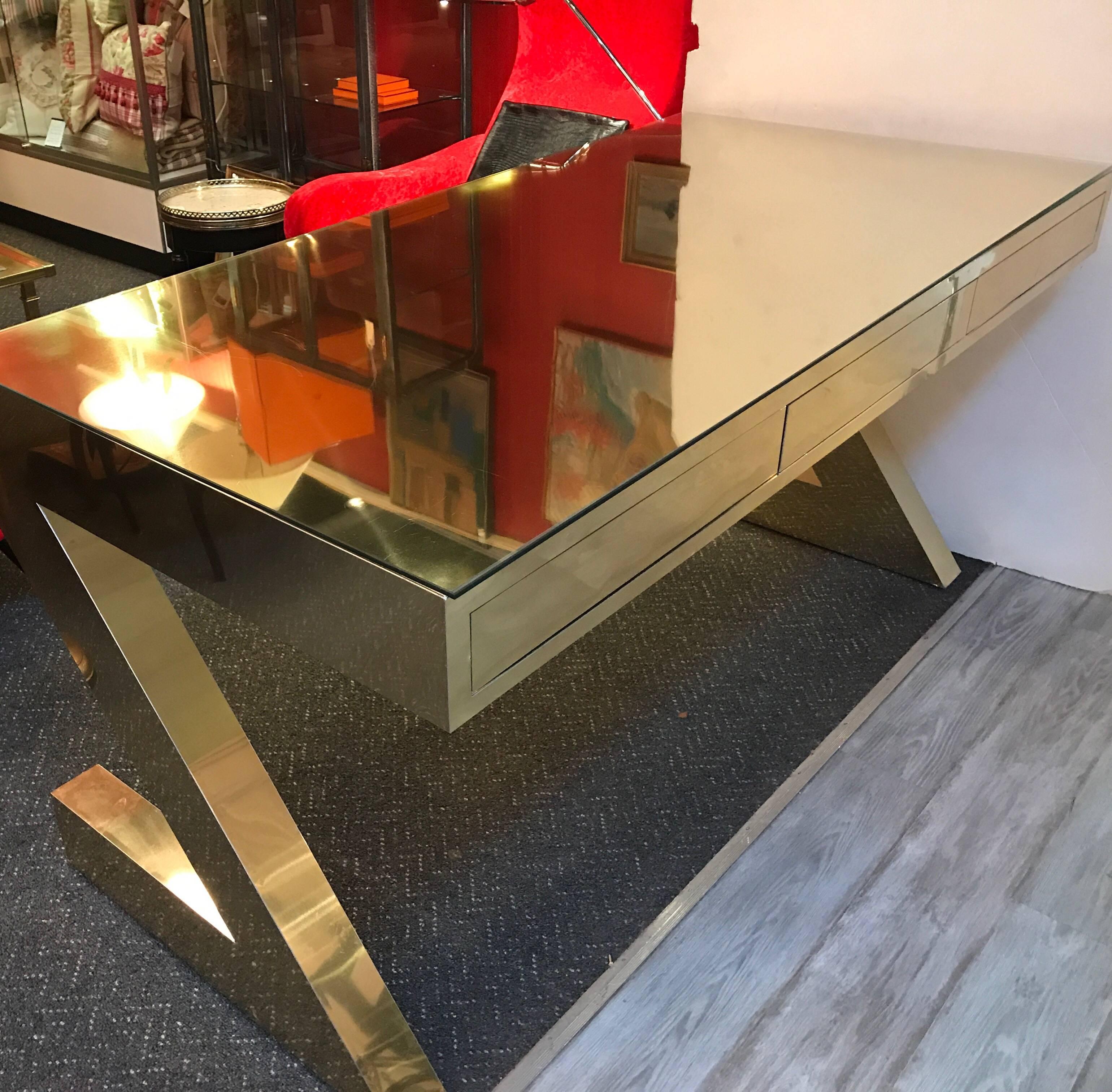 Brass Z desk The surface is covered with brass plated panels and has a custom glass protective top. The desk was a custom made designer piece made in NYC in the 1990s the surface is in good condition with some minor surface scratches. The desk front