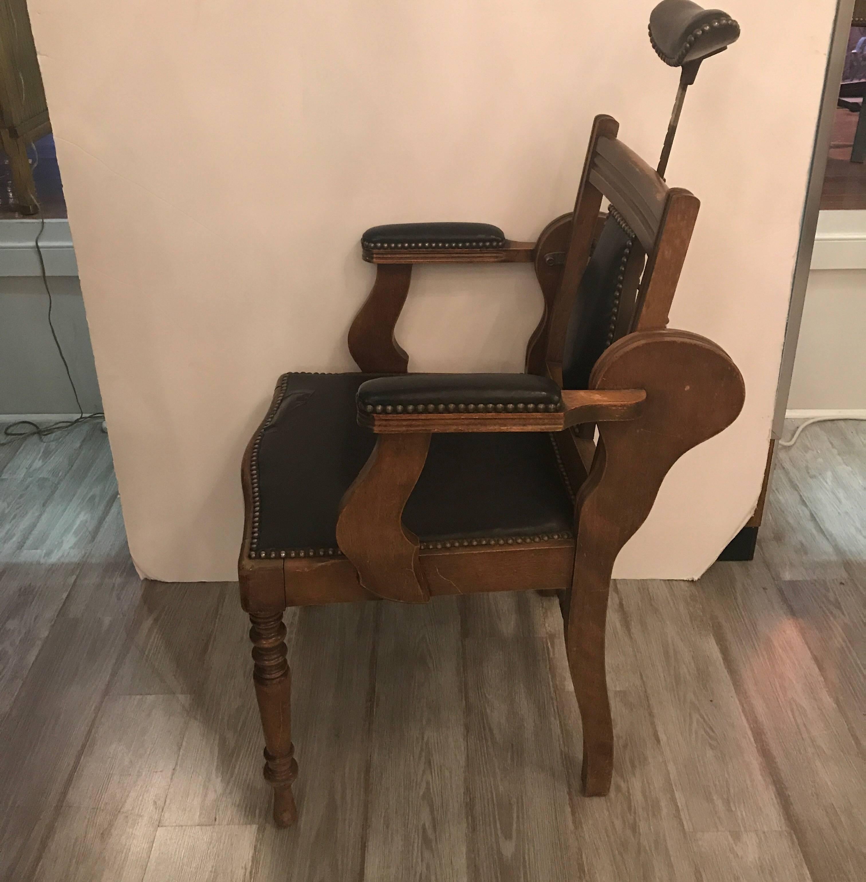 Unique and rare later 19th Century walnut dentist chair.  The adjustable head rest with a reclining back covered in black leather with nail head trim, the seat has a tear with a taped repair.  A piece this unusual can be left original or recovered. 