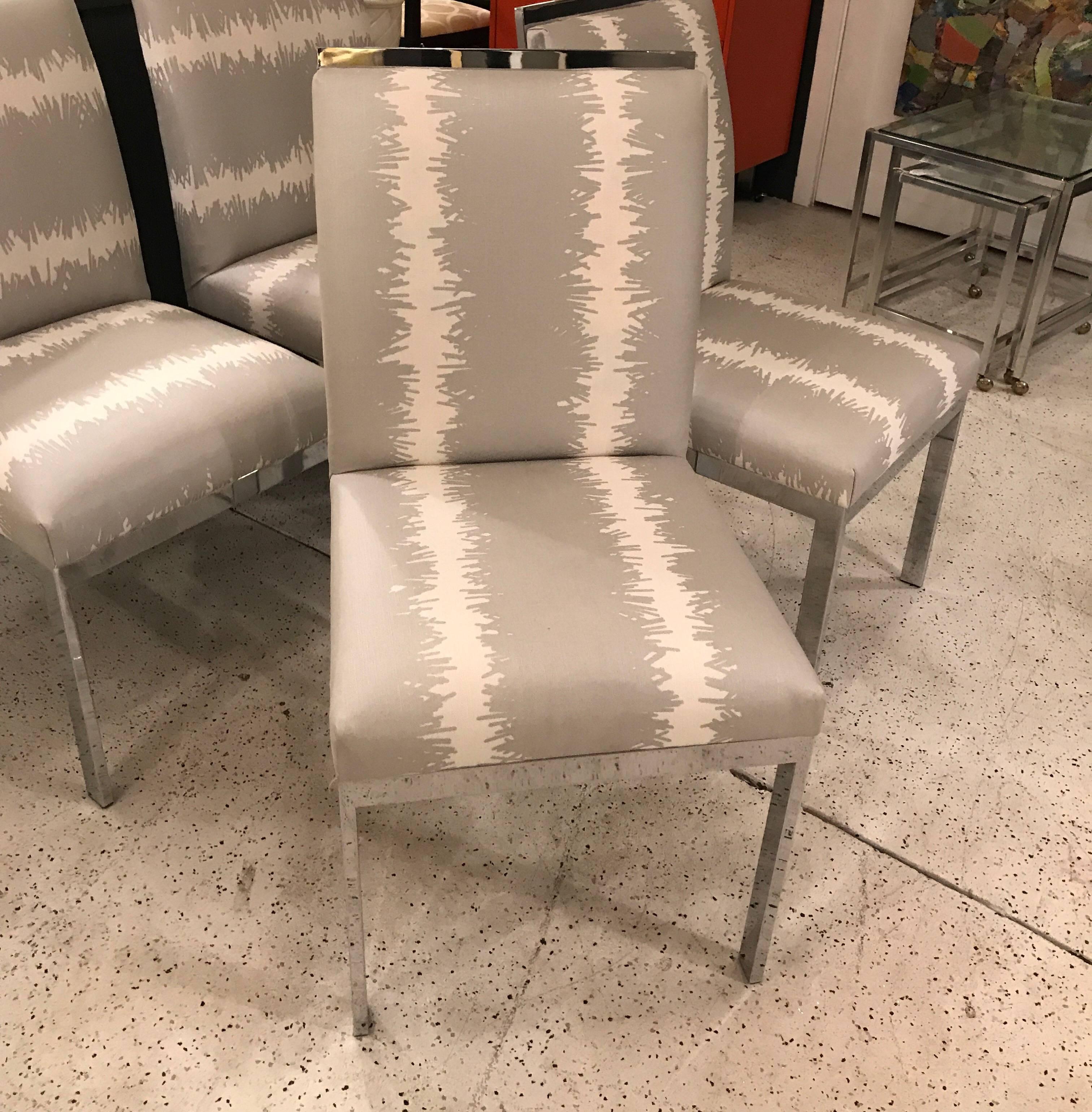 A set of four chrome parsons chairs with Schumacher Studio Bon BANG cotton linen fabric.  Two chairs are done with the fabric running vertically and the other two running horizontally.   