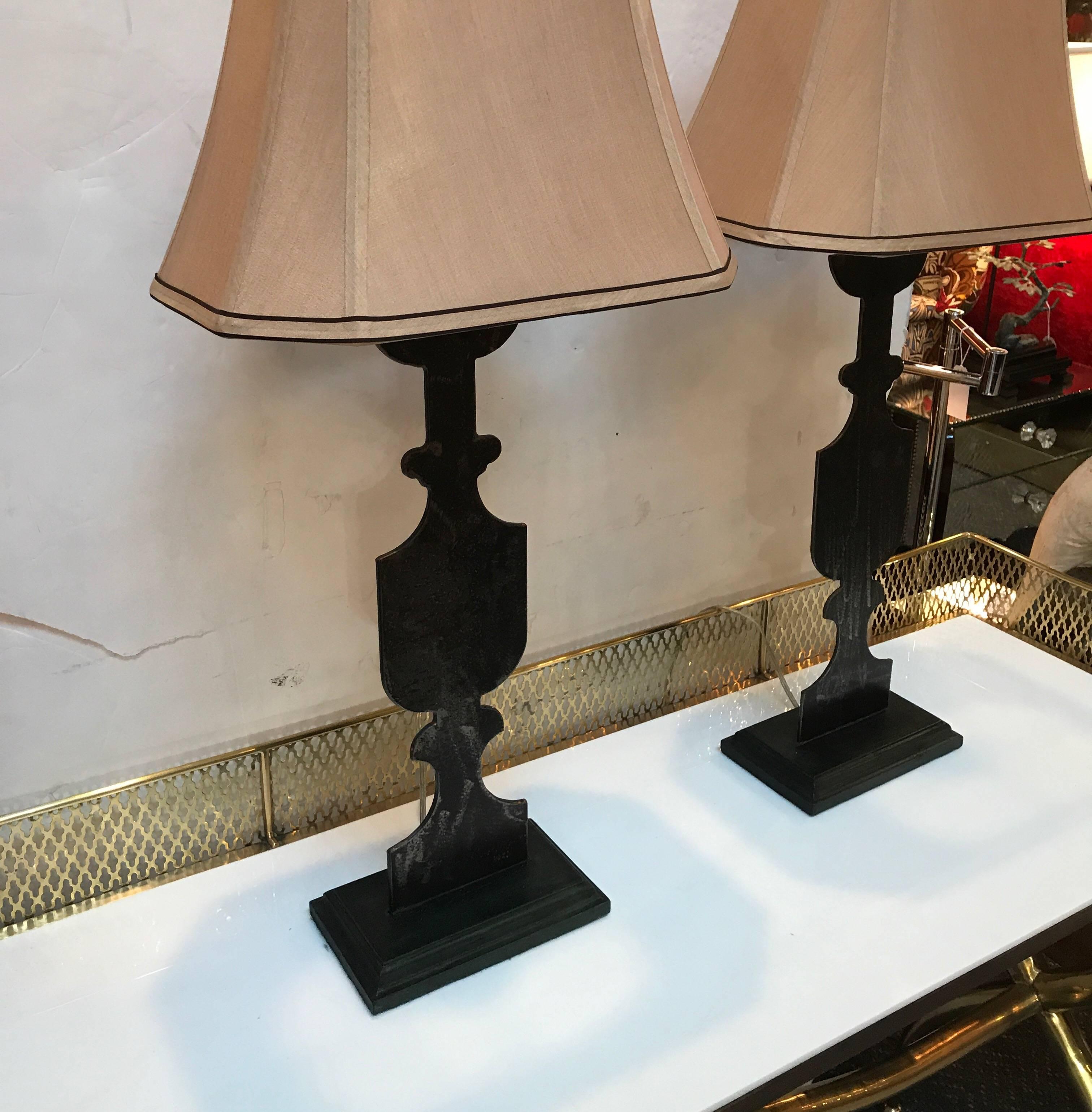 A pair of Industrial style Urn lams with square bases. The flat cut steel urns with painted to match wood bases. A two dimensional version of urns with an aged dark patinated finish. Topped is French Empire bell shades with black trim.