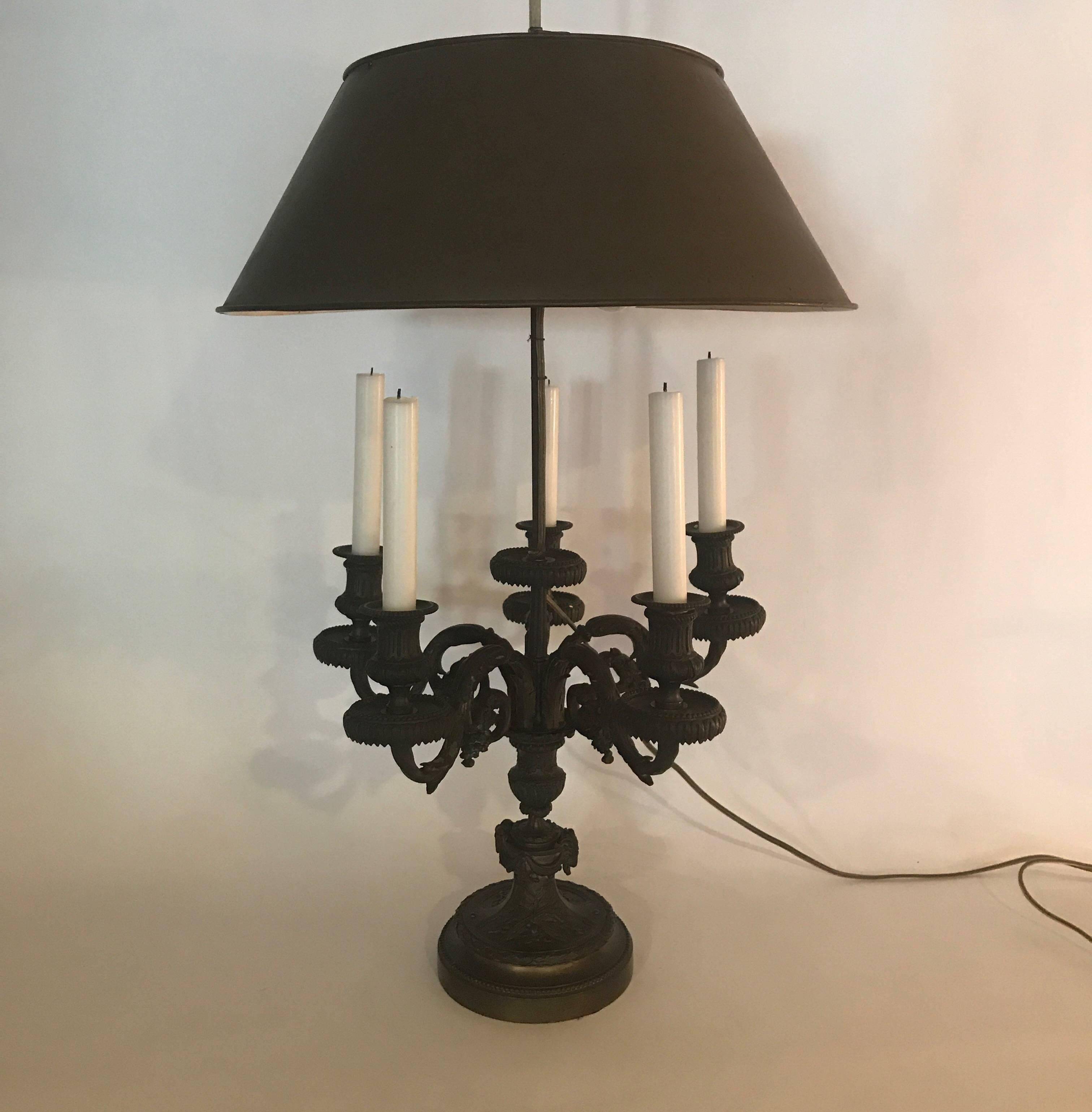 A patinated cast bronze bouillotte candelabra, now electrified. The finely cast details with five arms with the rod for the shade coming out the centre. The shade is finished to match the color of the base. The height to the top of the finial is 38