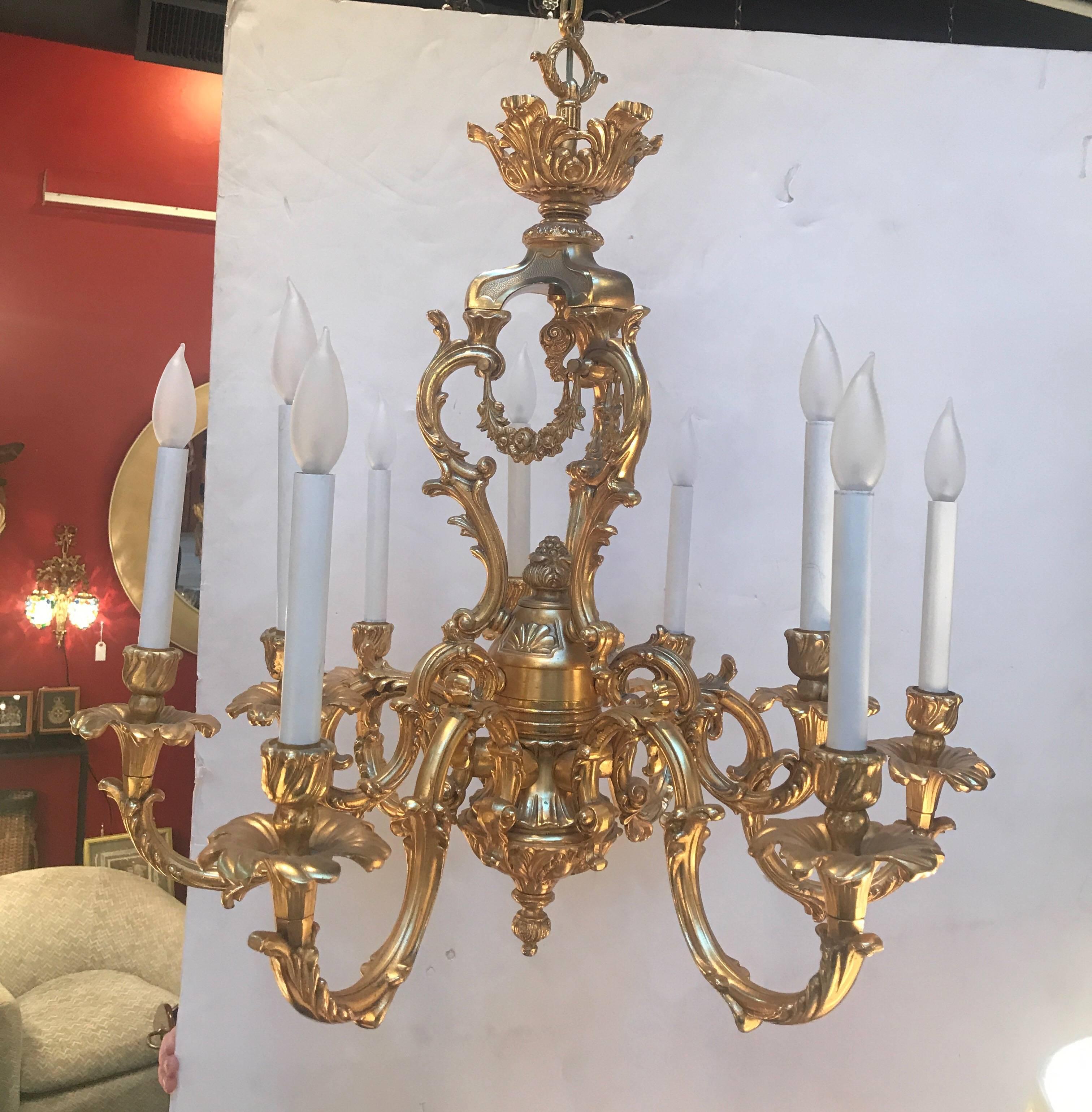 Stunning gilt cast bronze rococo Italian chandelier.  Elaborate style with a total of 9 lights.  Modern wiring and ready to hang.  