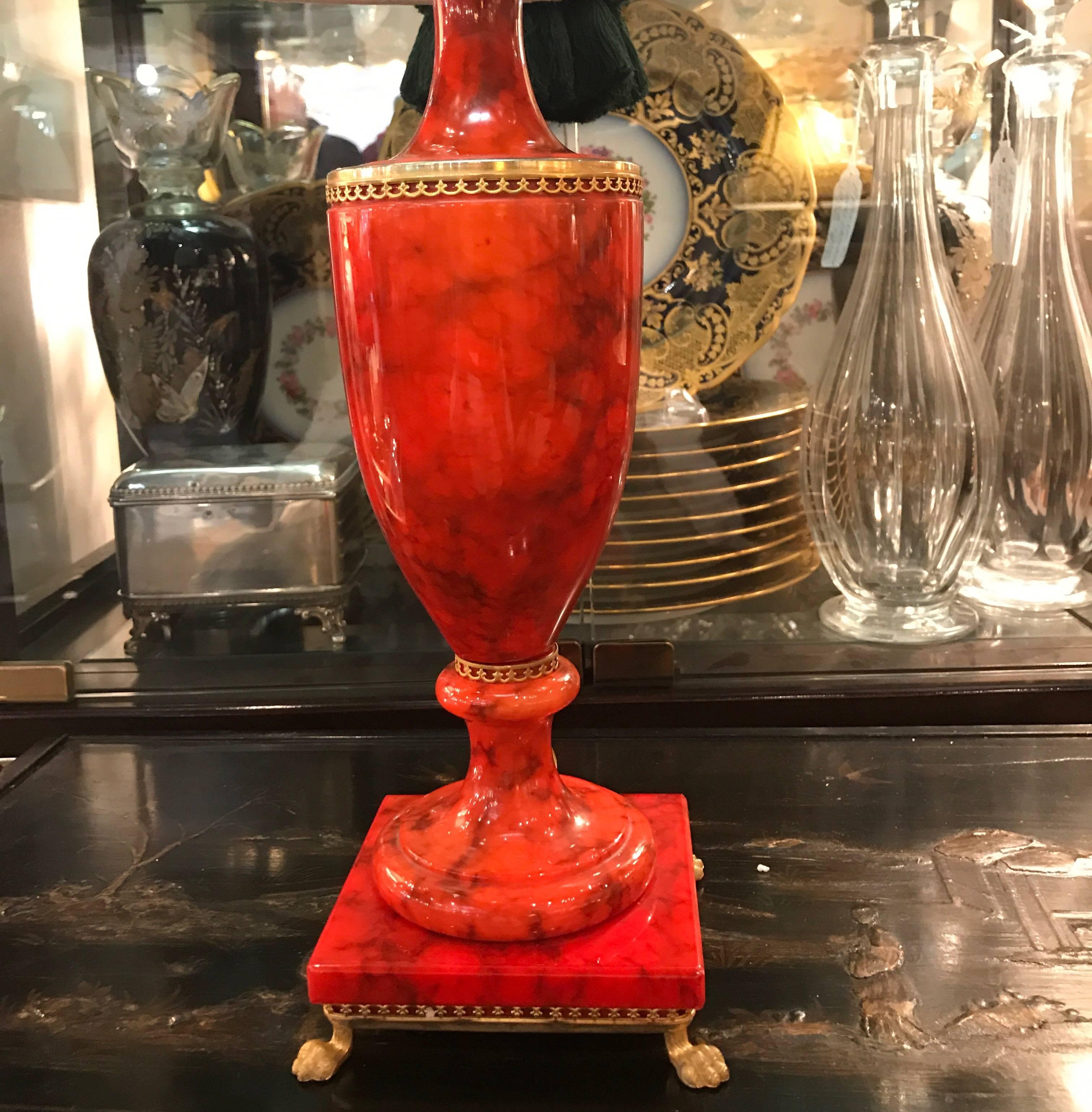 A Pair of vibrant red alabaster gilt mounted urn lamps.  Neoclassical urn form with new wiring and American sockets.  The shades are  for photographic purposes only and not included