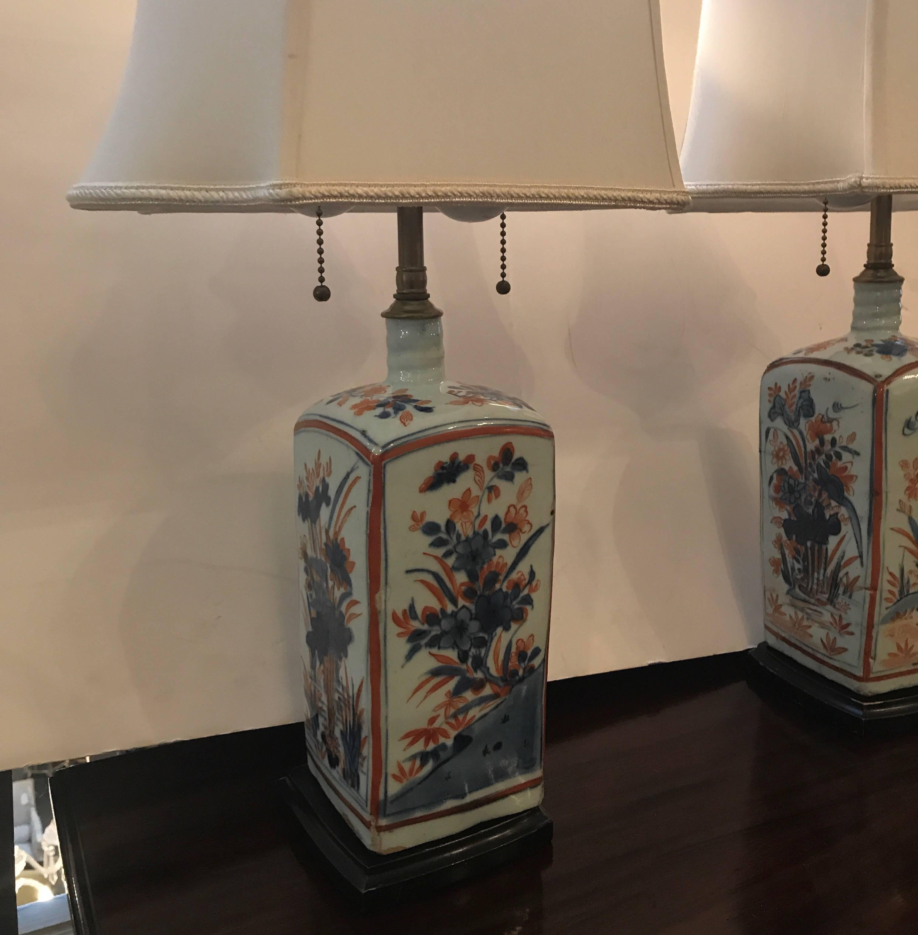 A pair of Imari pattern porcelain lamps. Although Imari is usually Japanese, these may be of Chinese origin. The porcelain is mid-late 18th century and was converted to lamps in the early part of the 20th century. Topped with custom silk shades.