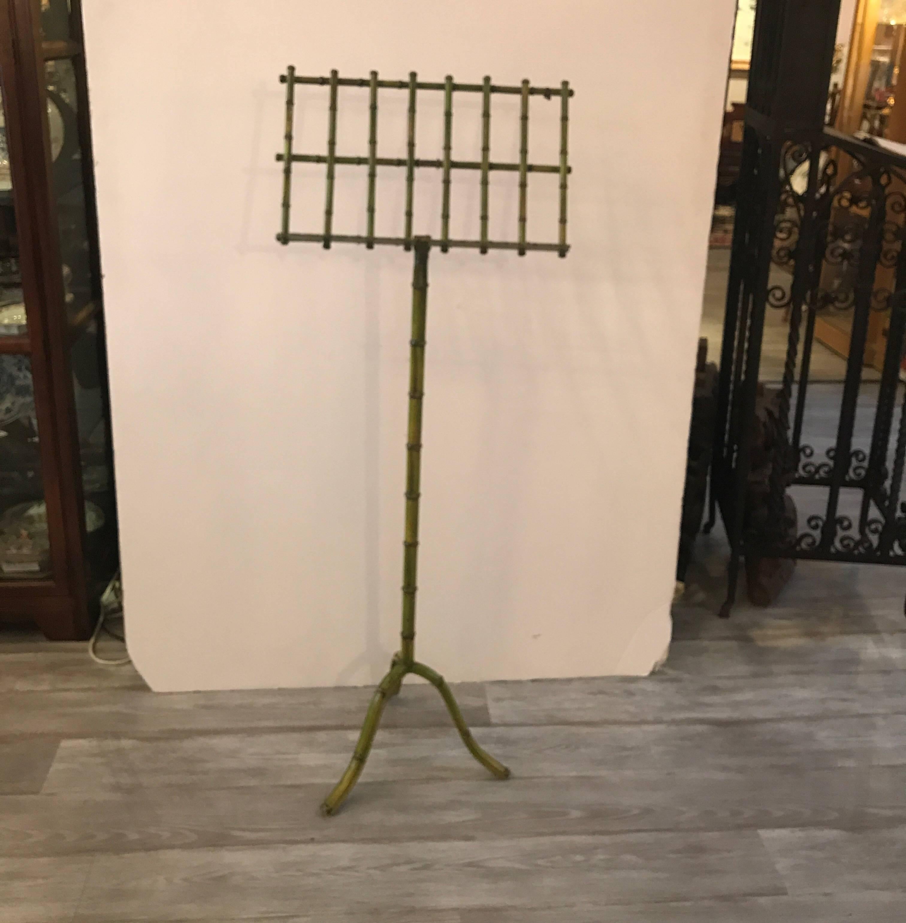 Whimsical painted metal bamboo motif Music stand made in Italy. The top of the stand is adjustable with a central pole on tripod base. All painted in a natural bamboo green finish.