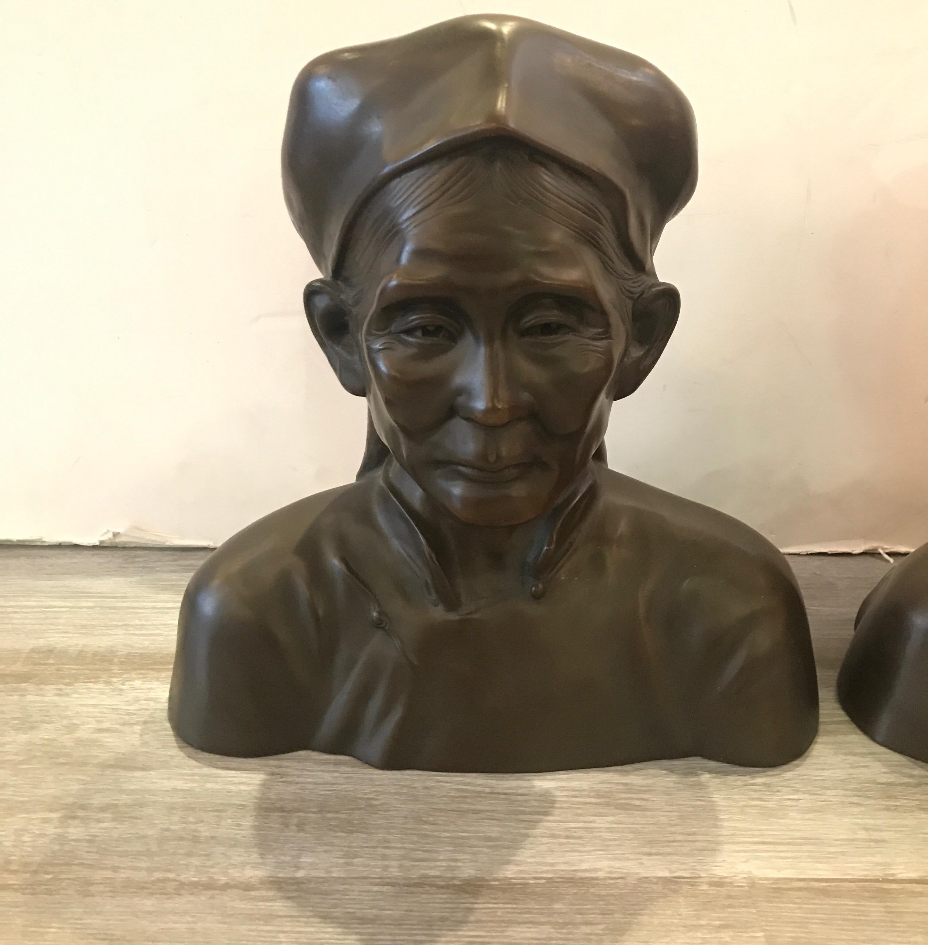 A fine pair of beautifully cast busts of an elderly Chinese couple. The French cast bronzes are a realistic and authentic depiction of a husband and wife.